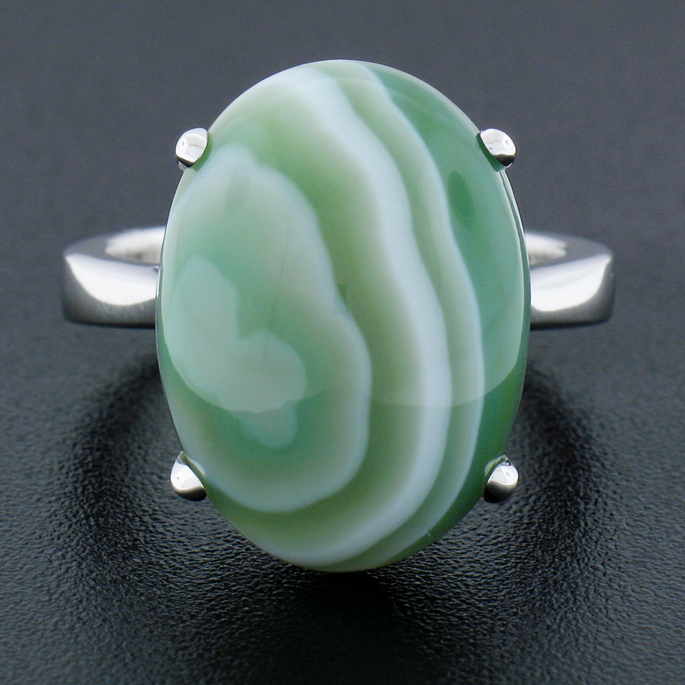 --Stone(s):--
(1) Natural Genuine Agate - Oval Cabochon Cut - Prong Set - Green Color with White Striations Lines - 18x13.2mm (approx.)

Material: Solid 14K White Gold
Weight: 7.76 Grams
Ring Size: 6.5 (Fitted on a finger. We can custom size this