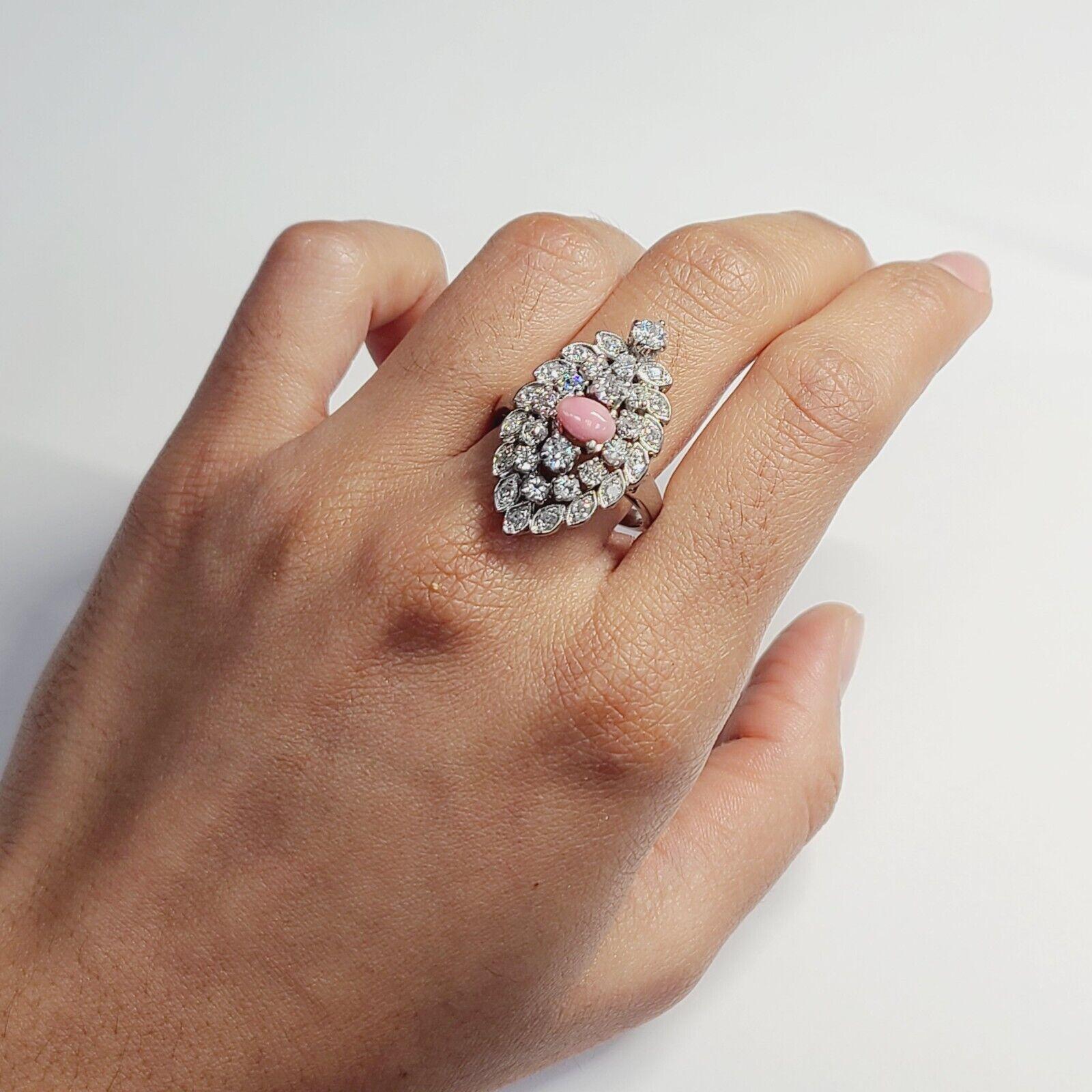 Presenting a:

14K White Gold 1.9ctw Old mine Diamond & Salmon Pink Conch Pearl Ring Size 8

Natural and earth mined Diamond pave and prong set in navette style with a natural pink conch pearl.

The ring measures 29mm wide, 12mm rise and 2.5mm shank