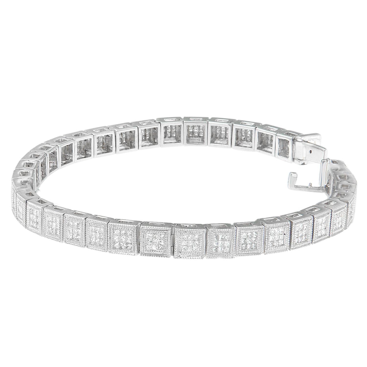 A modern geometric design gives this glamorous bracelet an undeniably bold look. Sprinkled with small, round diamonds inside chic cube links, this 14 karat white gold piece is nothing short of stunning. Bracelet has 306 natural, princess diamonds.