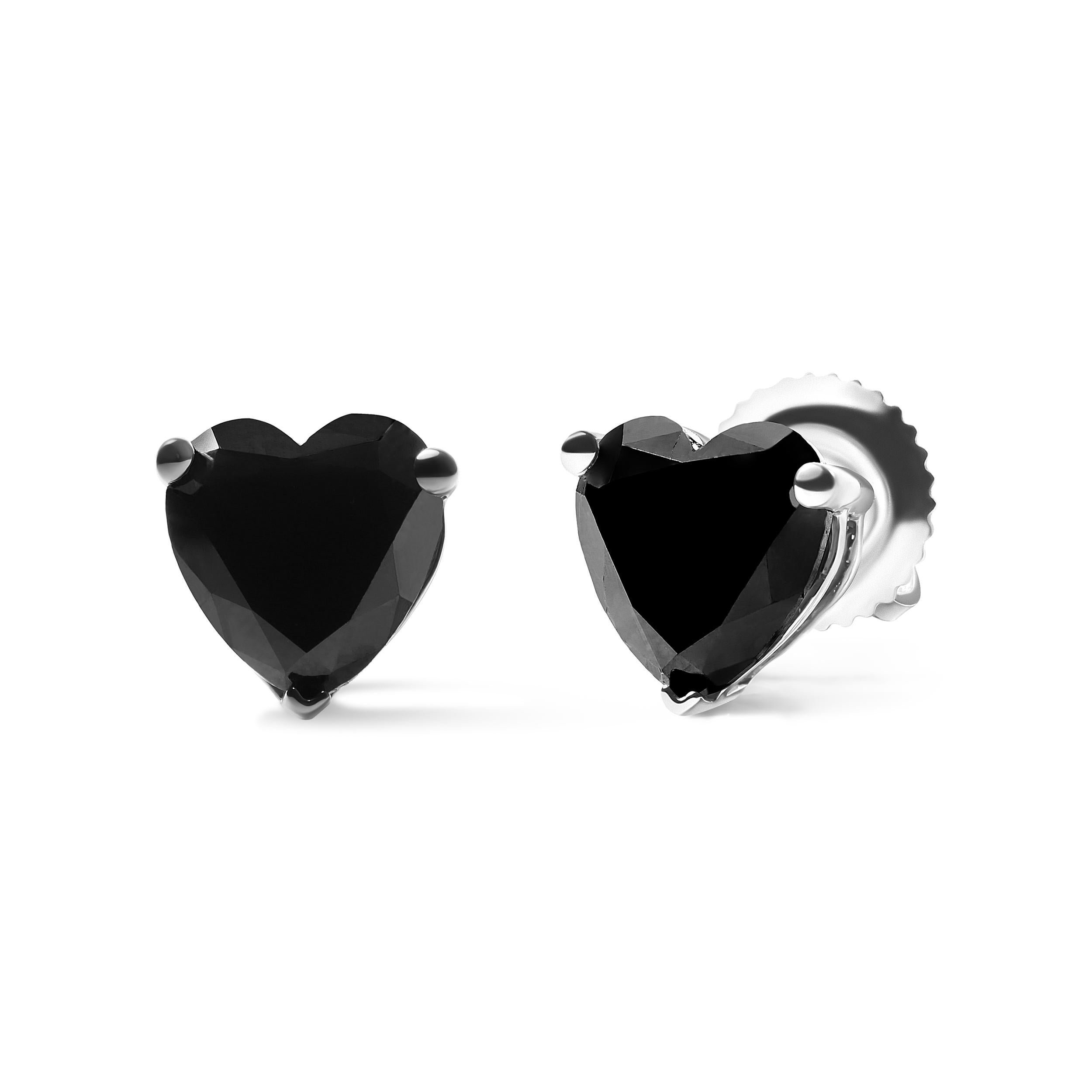 Indulge in the timeless elegance of 14K white gold with these stunning black heart shaped diamond solitaire stud earrings. The intricate design features two magnificent black diamonds, each weighing 1.0 carats total of 2.0 carats and framed by a