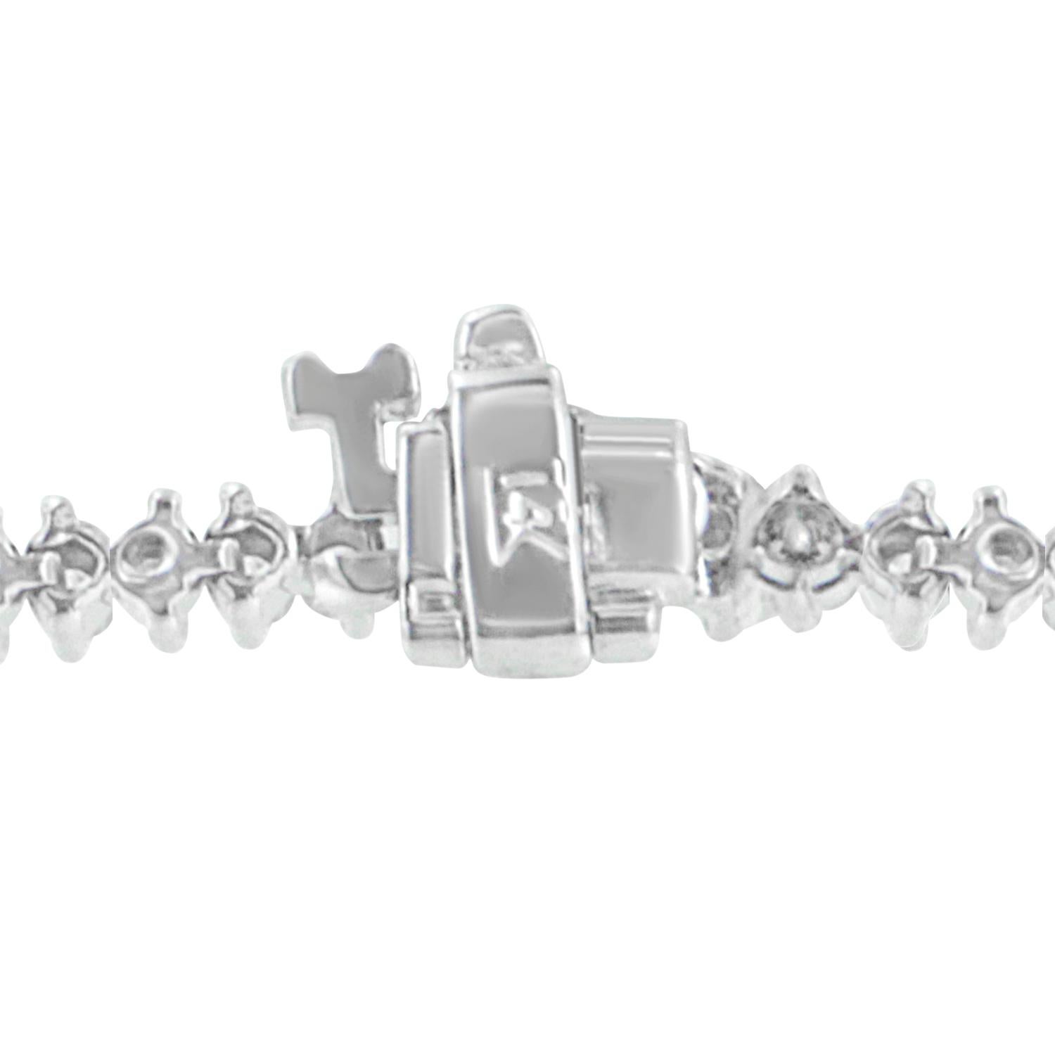Classic round cut diamonds totaling 2 carats are the centerpiece for this beautiful 14 karat white gold bracelet. Featuring a two-prong setting, each stone sparkles as bright as her smile. Bracelet has 88 natural, round diamonds. Each stone weighs