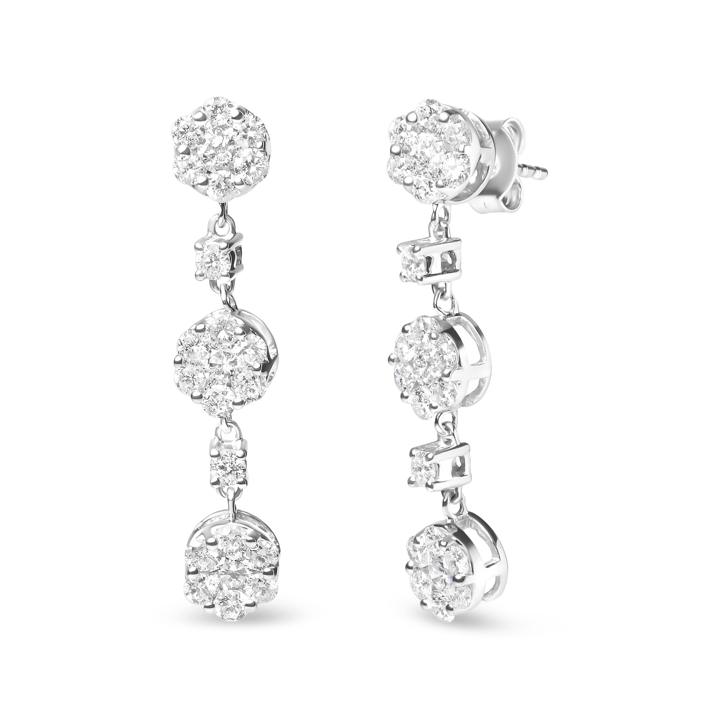 Indulge in the beauty of nature with these stunning 14K white gold floral drop earrings. Each earring features a mesmerizing composite cluster of 46 round diamonds, totaling 2.00 cttw. The diamonds, all natural in origin, boast a stunning I-J color