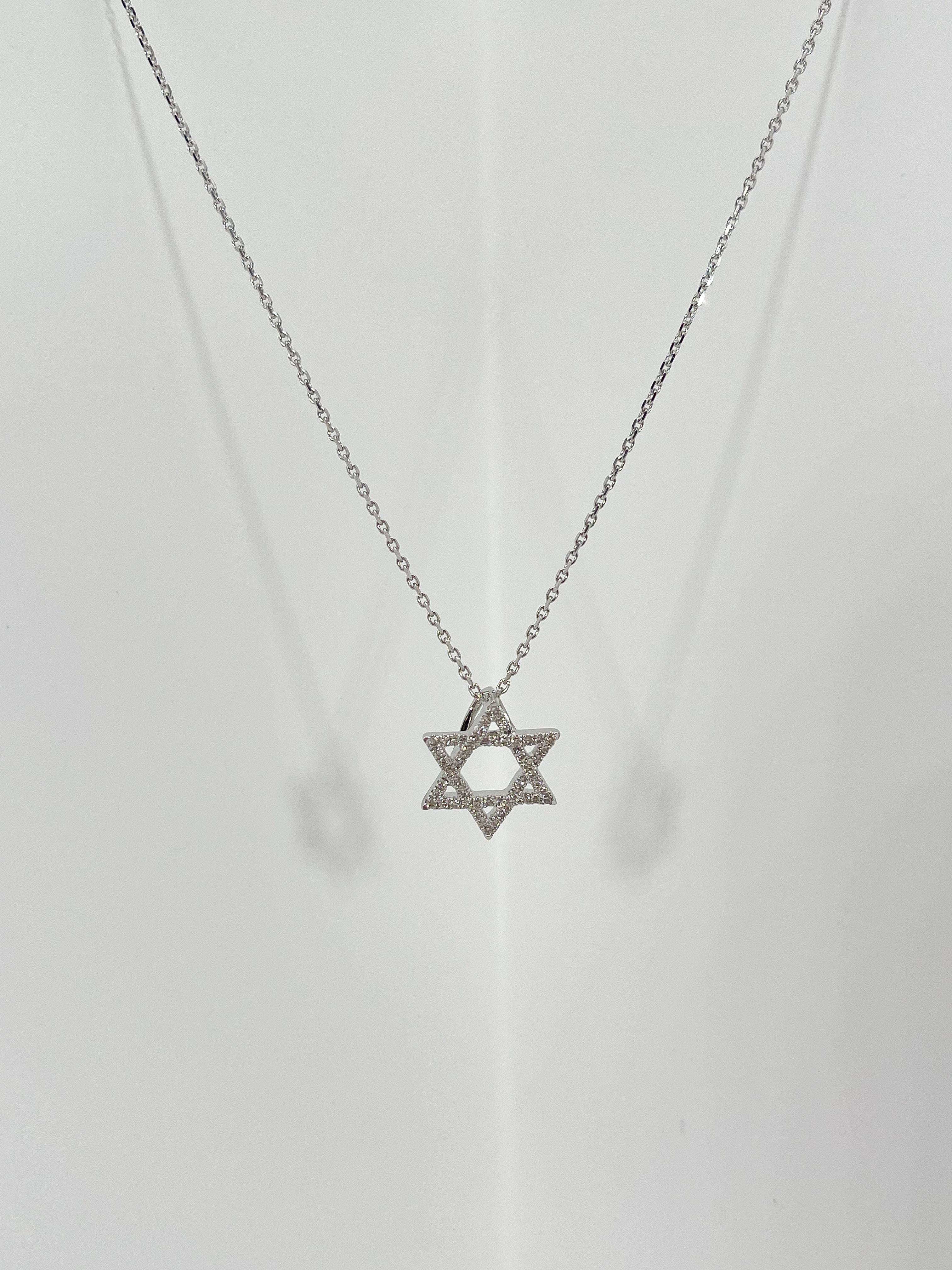 14k white gold .21 CTW diamond Star of David pendant necklace. The diamonds in the pendant are all round, the pendant measures to be 13.5mm x 12mm, has a lobster clasp to open and close, pendant comes on an 18 inch diamond cut cable chain, and has a