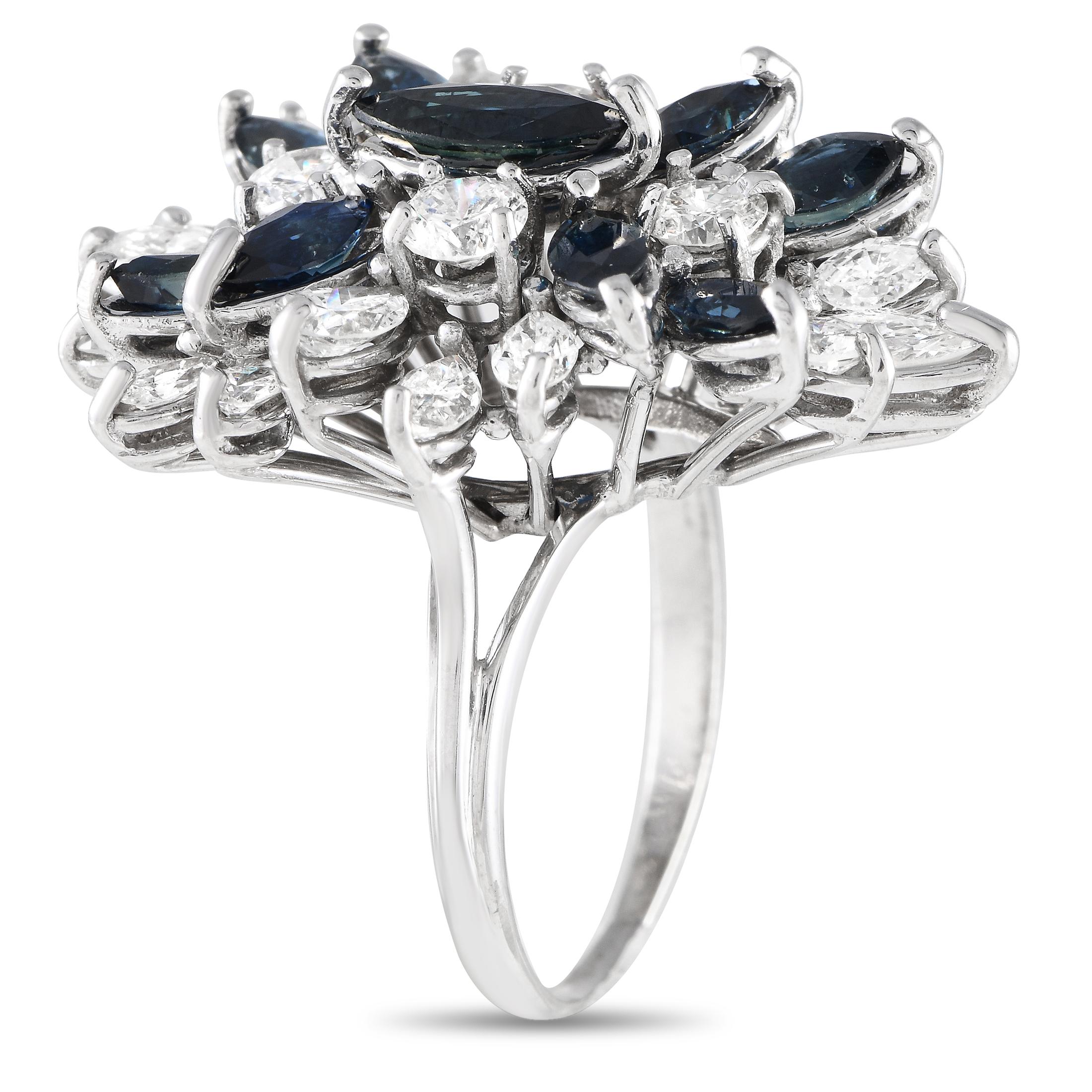 Not to miss is the graceful and glittering charm of this diamond and sapphire cluster ring. Meant to be worn as a statement-making piece, this 14K yellow gold band shines with 2.20 carats of diamonds in various cuts. Adding a hint of mysterious