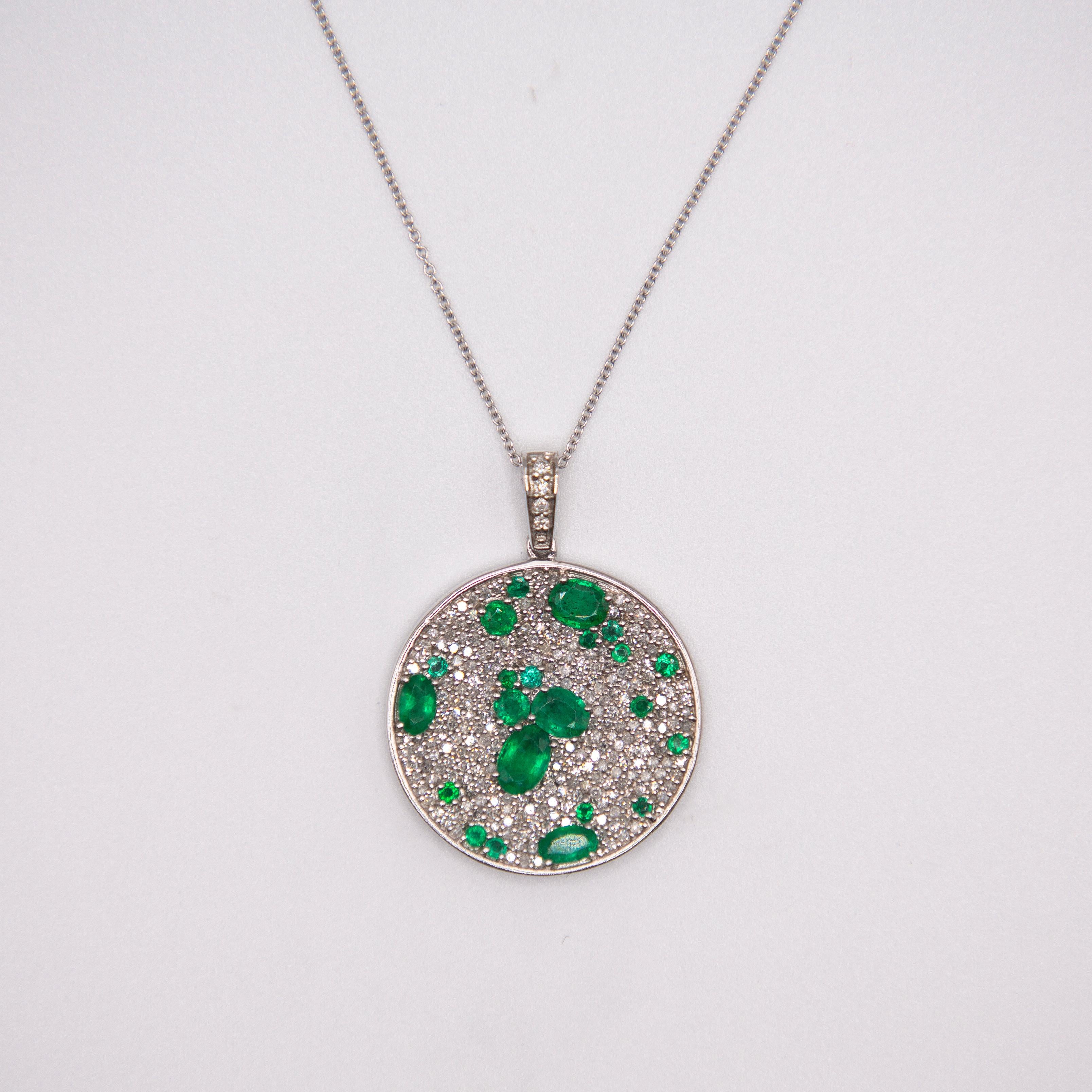 A stunning array in an Artsy presentation, fine dark green emeralds are sprinkled amongst fine G colors white diamonds set in 14k white gold. Diamonds 1.24ct.  with Zambian emeralds  totaling 2.30 cts. 