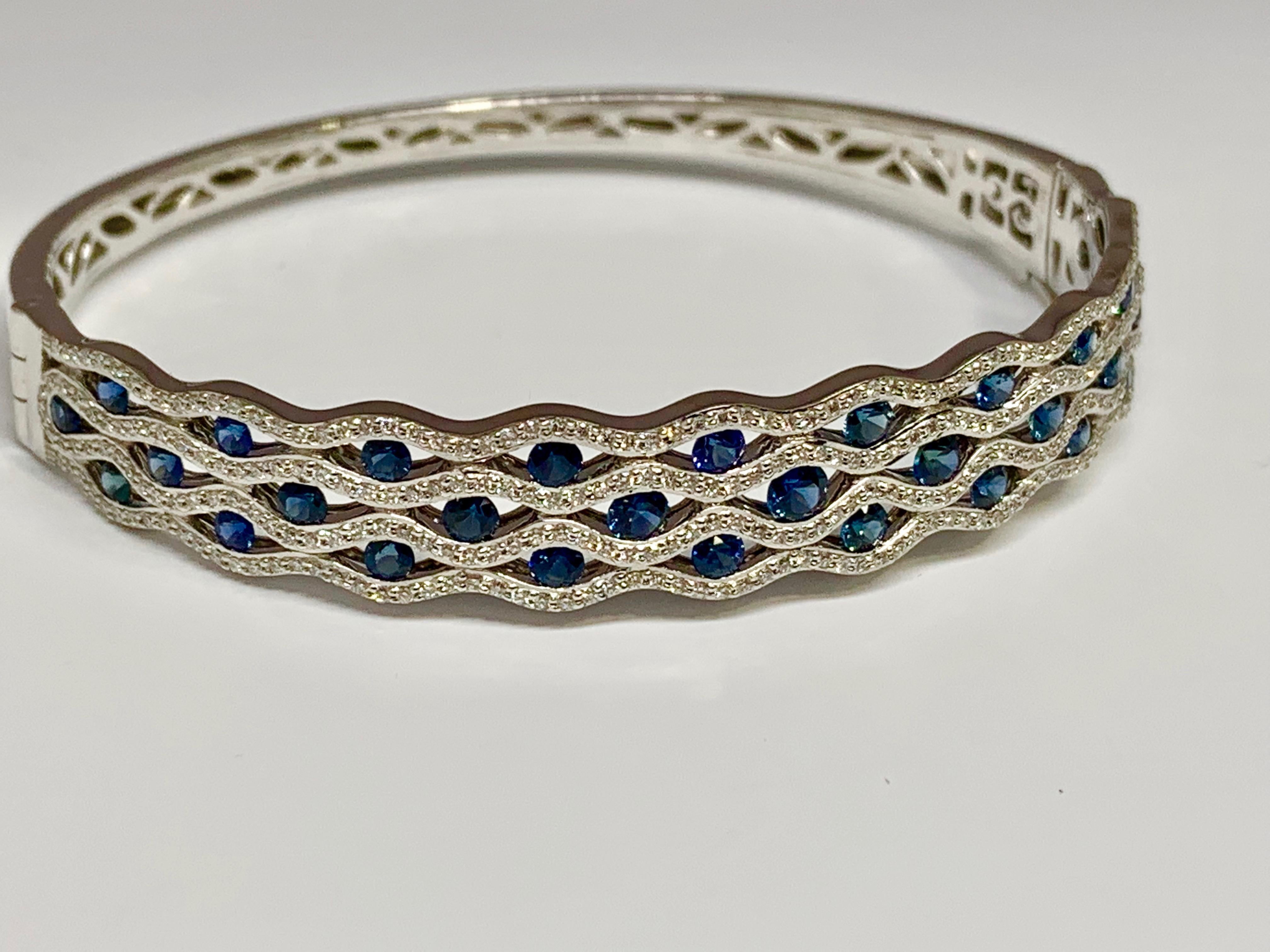 This stunning Allison-Kaufman Company 14K white gold bracelet features a romantic scalloped design and 2.34 total carats of round diamonds and beautiful round blue sapphires. The bracelet includes a box clasp and a figure 8 safety clasp for extra