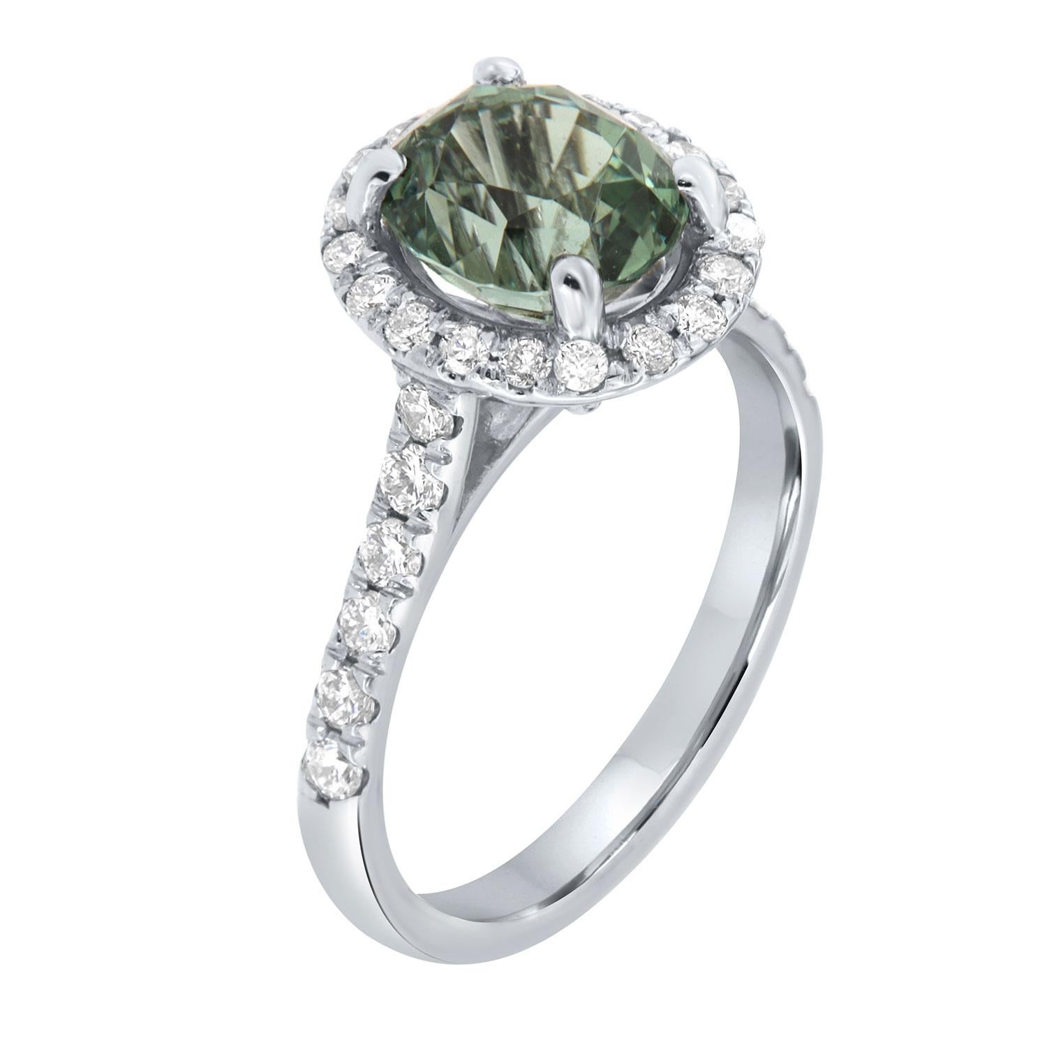 This ring features an oval-shaped light, vibrant green color 2.47-carat Tourmaline encircled by nineteen (19) or brilliant round diamonds Micro-Prong -Set. Twelve (12) 2mm size brilliant diamonds are micro-prong set on top of a 2.3 mm wide band. The