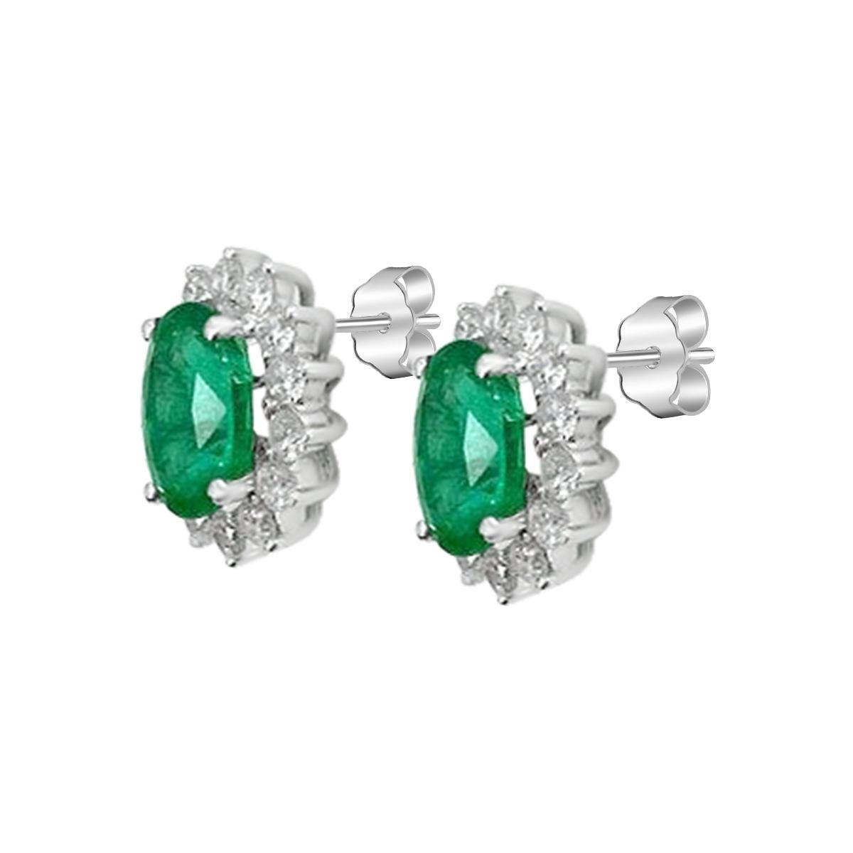 Dieses zeitlos elegante Paar Ohrstecker verfügt über einen sattgrünen 8 x 6 mm großen Smaragd im Ovalschliff, der von Diamanten umgeben ist. Die Smaragde sind eine gleichmäßige und gut gesättigte  Grüner Farbton, der an üppiges Sommerlaub erinnert.