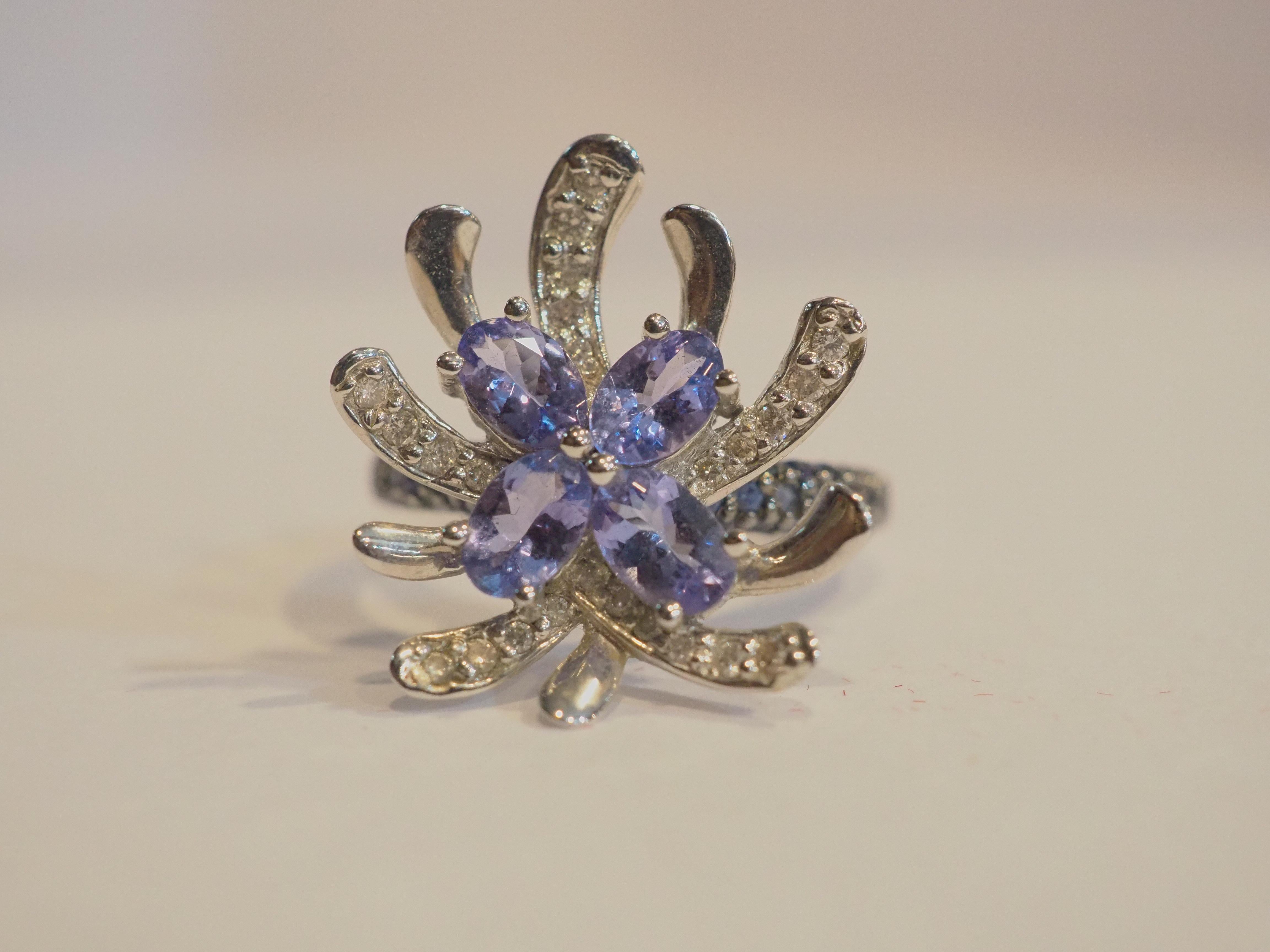 This quality and beautiful wide face flowery cluster ring piece is an 14K solid yellow gold with 4 fine quality oval tanzanite shank which is decorated with pave blue sapphires and branches are decorated with sparkling diamond. The 4 tanzanite are