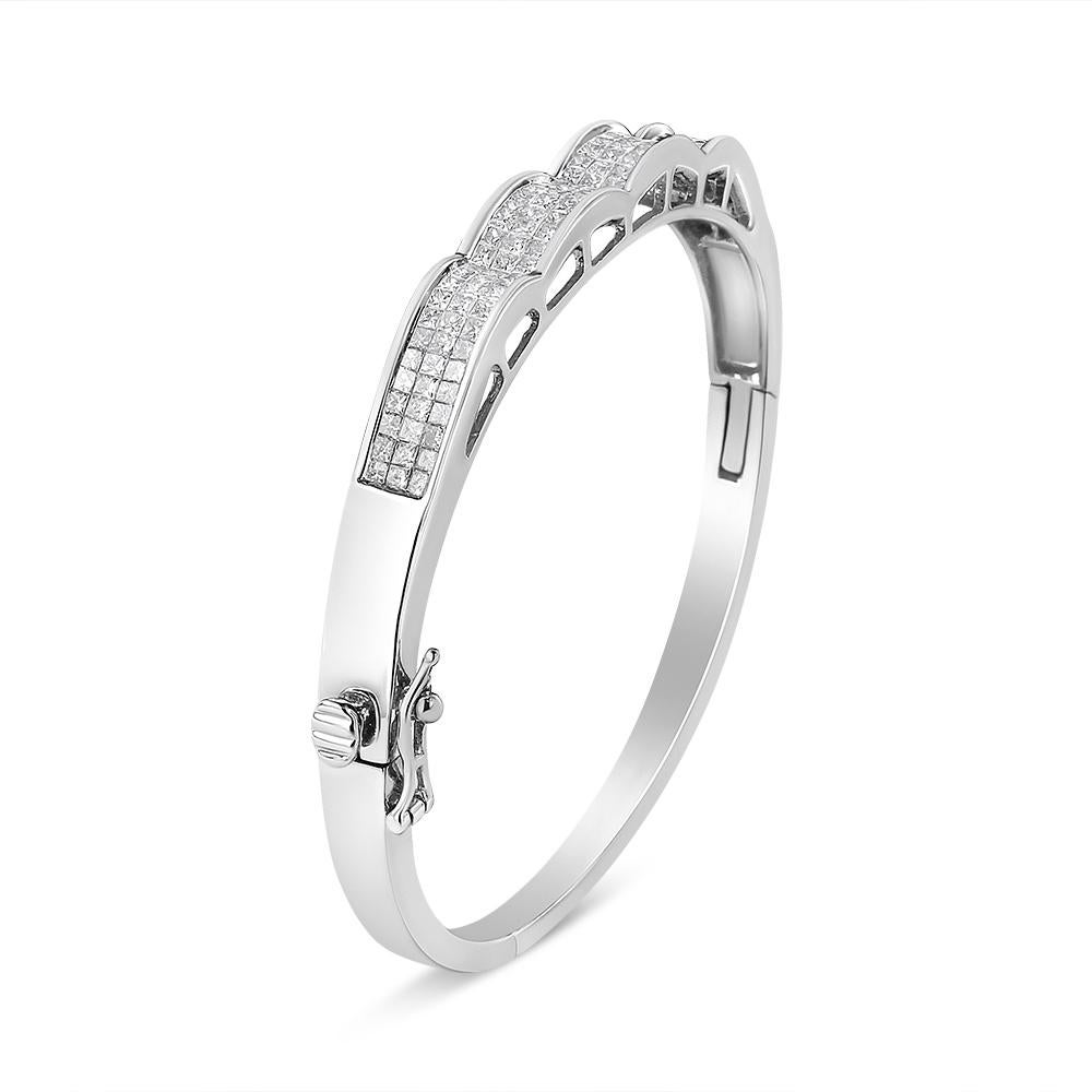 Modern and unique, this beautiful design will bring a glamorous touch to her jewelry collection. This bangle is created in the finest 14k white gold and is expertly set with natural diamonds in a wave-like pattern. The diamonds are princess-cut and