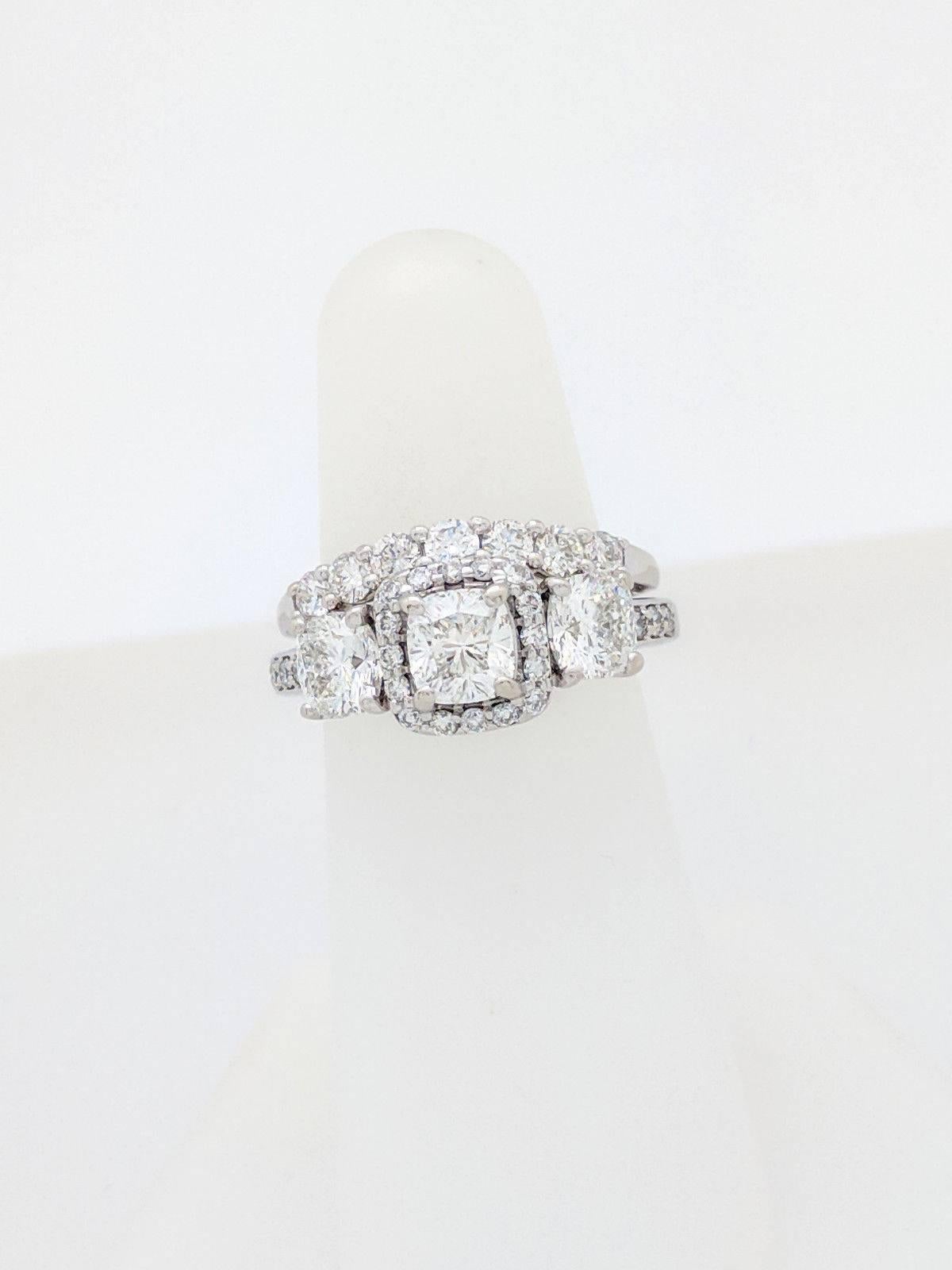 14K White Gold 3-Stone Cushion Cut 2.62ctw Diamond Halo Wedding Set IGI Cert.

You are viewing a beautiful IGI Certified 3-Stone Cushion Cut Diamond Wedding Set. The engagement ring features (1) .72ct natural cushion cut diamond with a diamond halo,