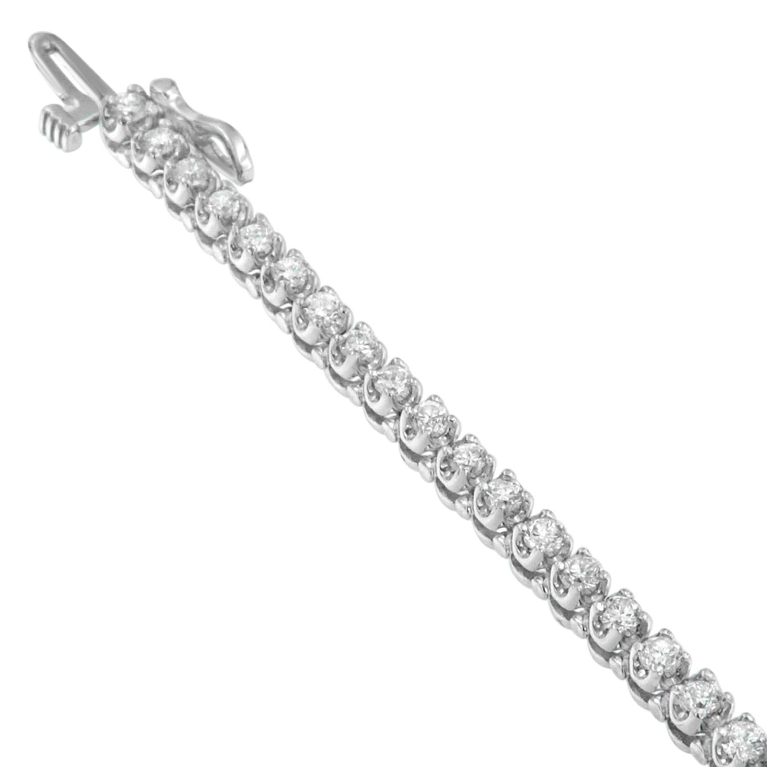 This 14K white gold bracelet features a symmetrical pattern of round cut diamonds lending it a stunning, shimmering effect. The flexibility and sleekness make it very attractive and wearable every day with any outfit. It is sure to make statements
