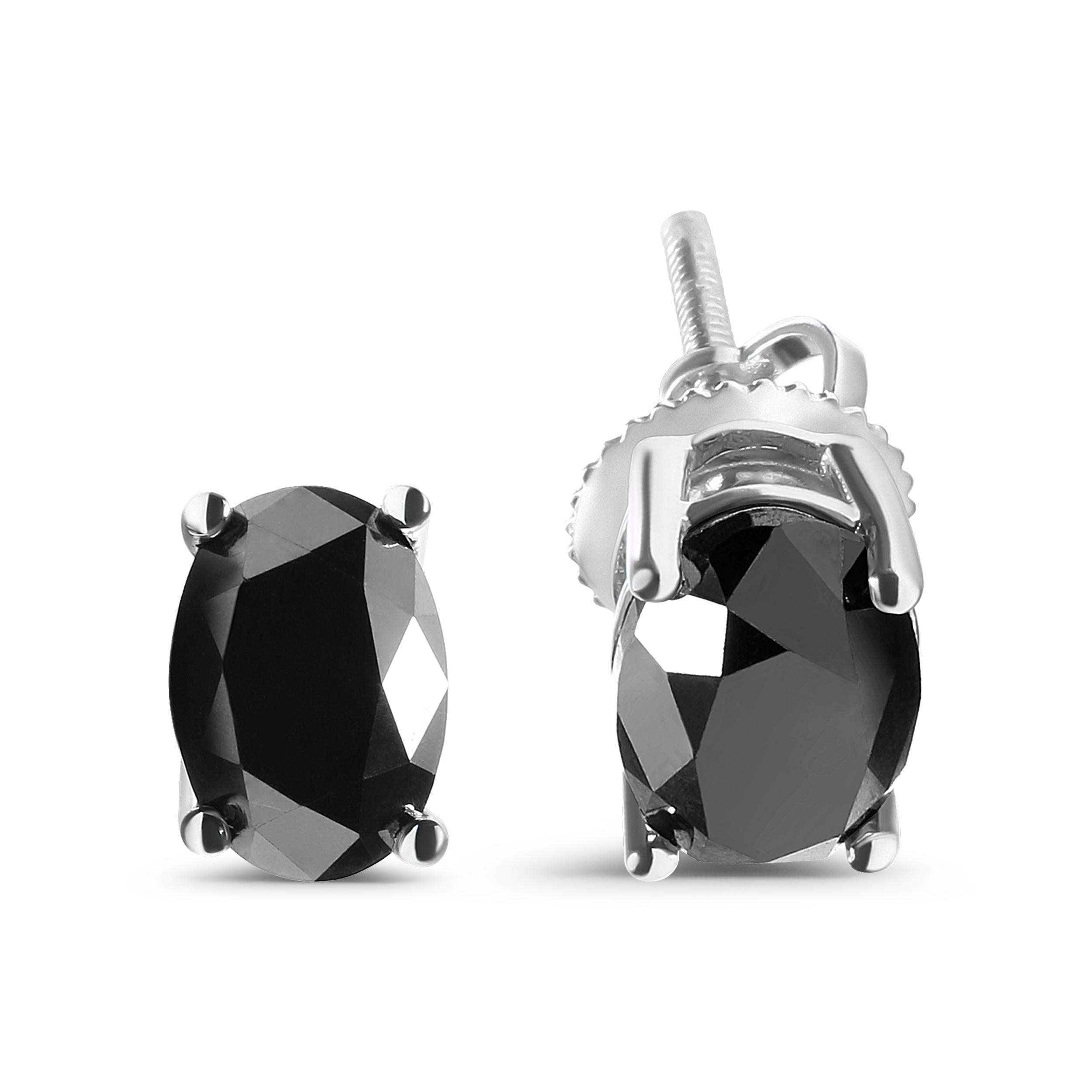 These elegant stud earrings are a true statement piece. Made from 14K white gold, they feature two stunning oval cut black diamonds totaling 3 carats. These natural diamonds have been color treated to enhance their unique hue, giving them a dramatic