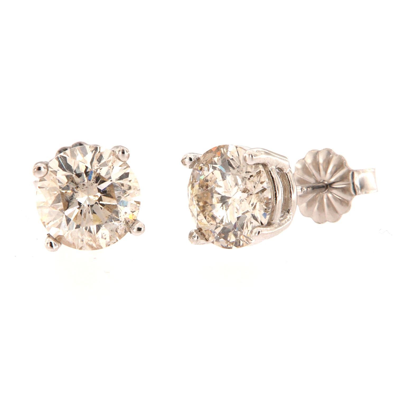 These 14k White gold studs feature two perfectly matched brilliant round diamonds in a total weight of 3.17 carat ( 1.58+1.59 each) Four (4) pongs basket settings. 

Average Color: 