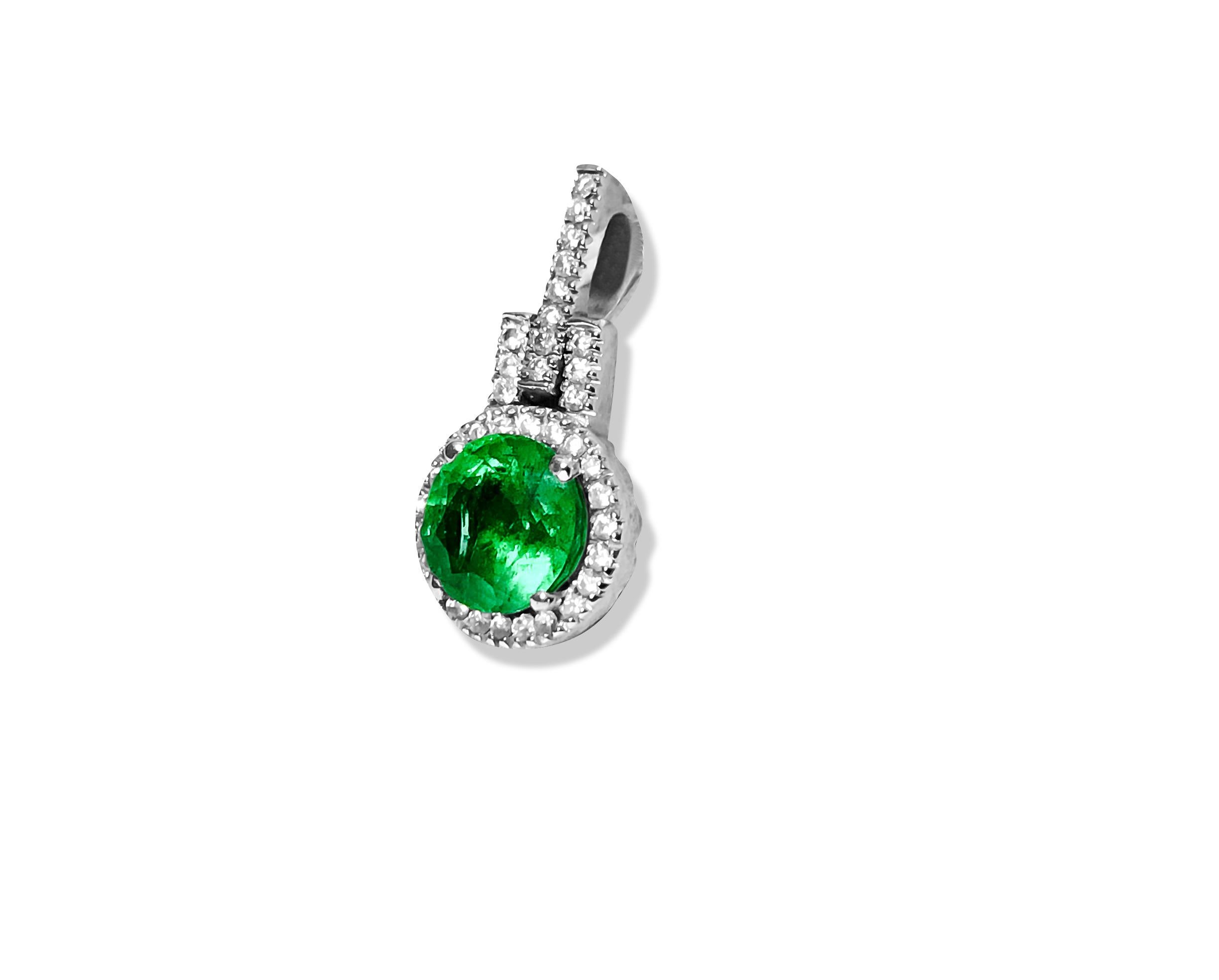 Crafted from elegant 14K white gold, this pendant showcases a captivating 2.00-carat round-cut emerald, securely nestled in a prong setting. Encircling the emerald are dazzling diamonds totaling 1.20 carats, boasting VS-SI clarity and G color. With