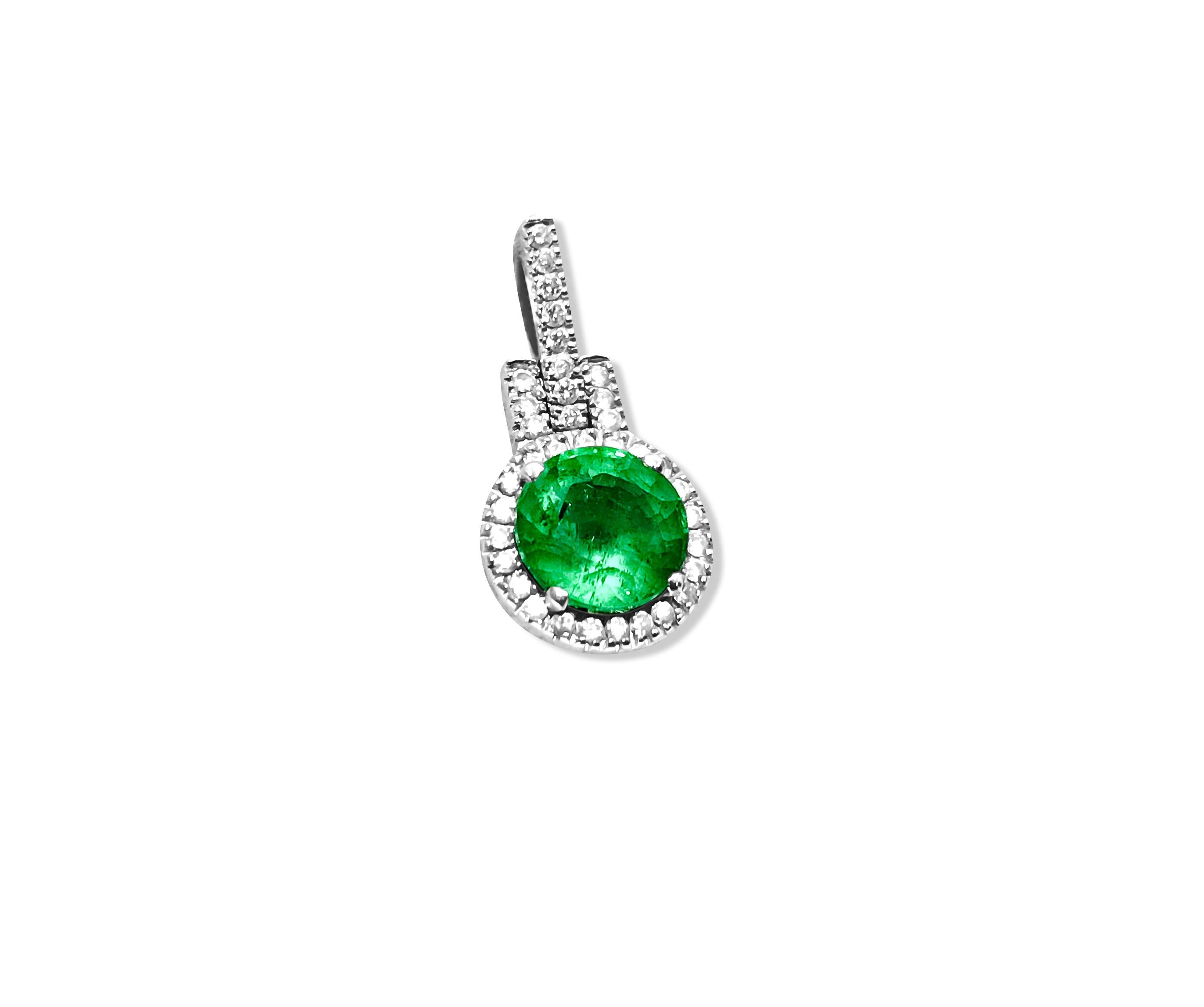 Crafted from elegant 14K white gold, this pendant showcases a captivating 2.00-carat round-cut emerald, securely nestled in a prong setting. Encircling the emerald are dazzling diamonds totaling 1.20 carats, boasting VS-SI clarity and G color. With