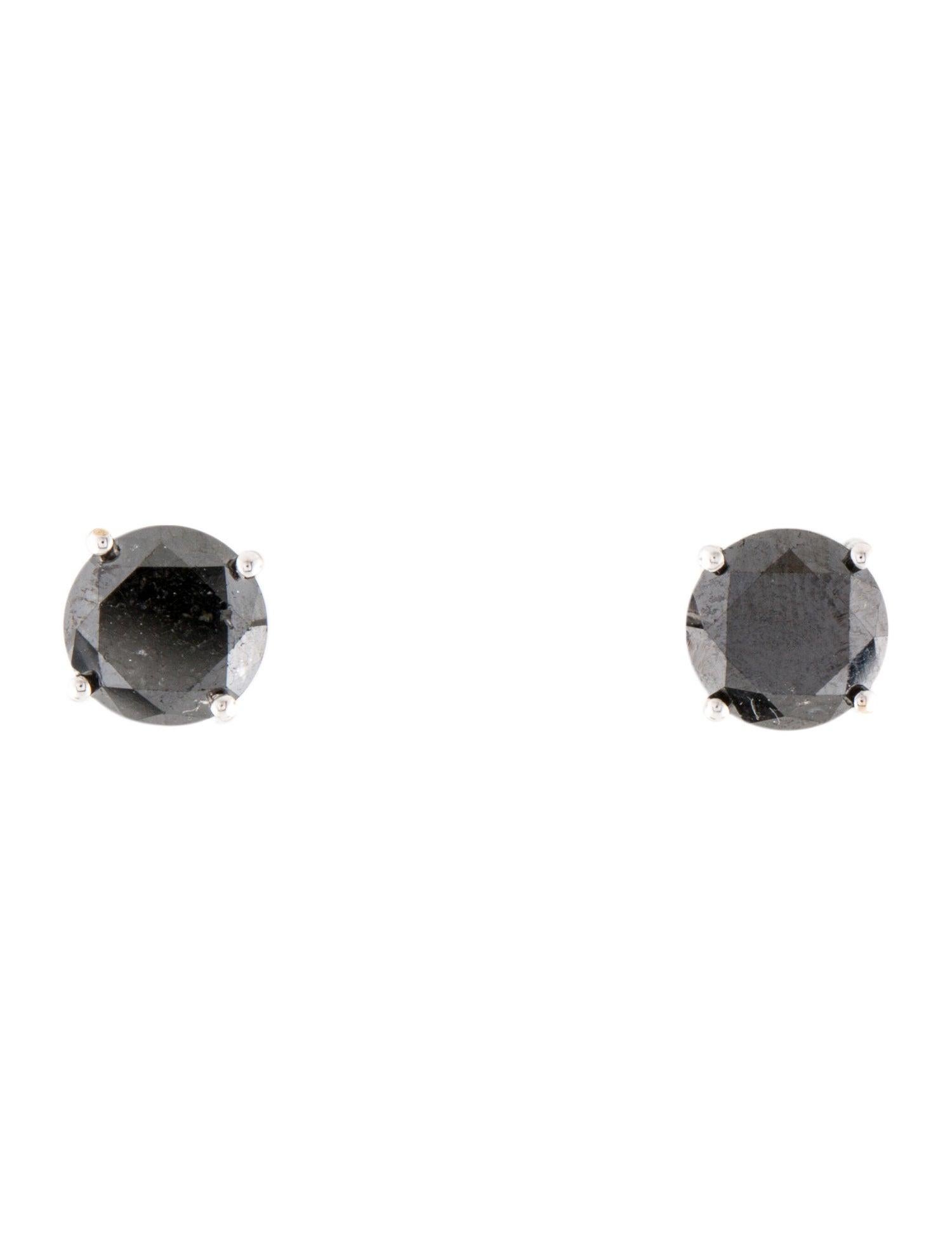 Elevate your jewelry collection with our striking 14K White Gold Black Diamond Stud Earrings, featuring a total carat weight of 3.25ctw. These earrings showcase two magnificent round brilliant black diamonds, color enhanced to draw attention and