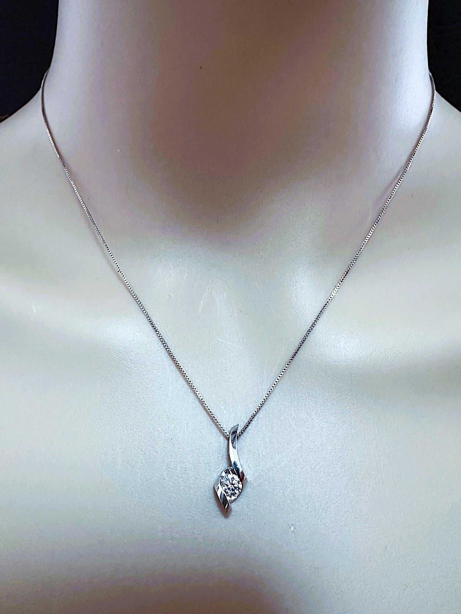 This is a beautiful dainty classic necklace with a brilliant cut diamond beautifully affixed in a 14k white gold twisted setting.   It is from the Sirena Collection and is very simple and elegant.  The diamond is 4.2 mm totaling .33 carats.  The