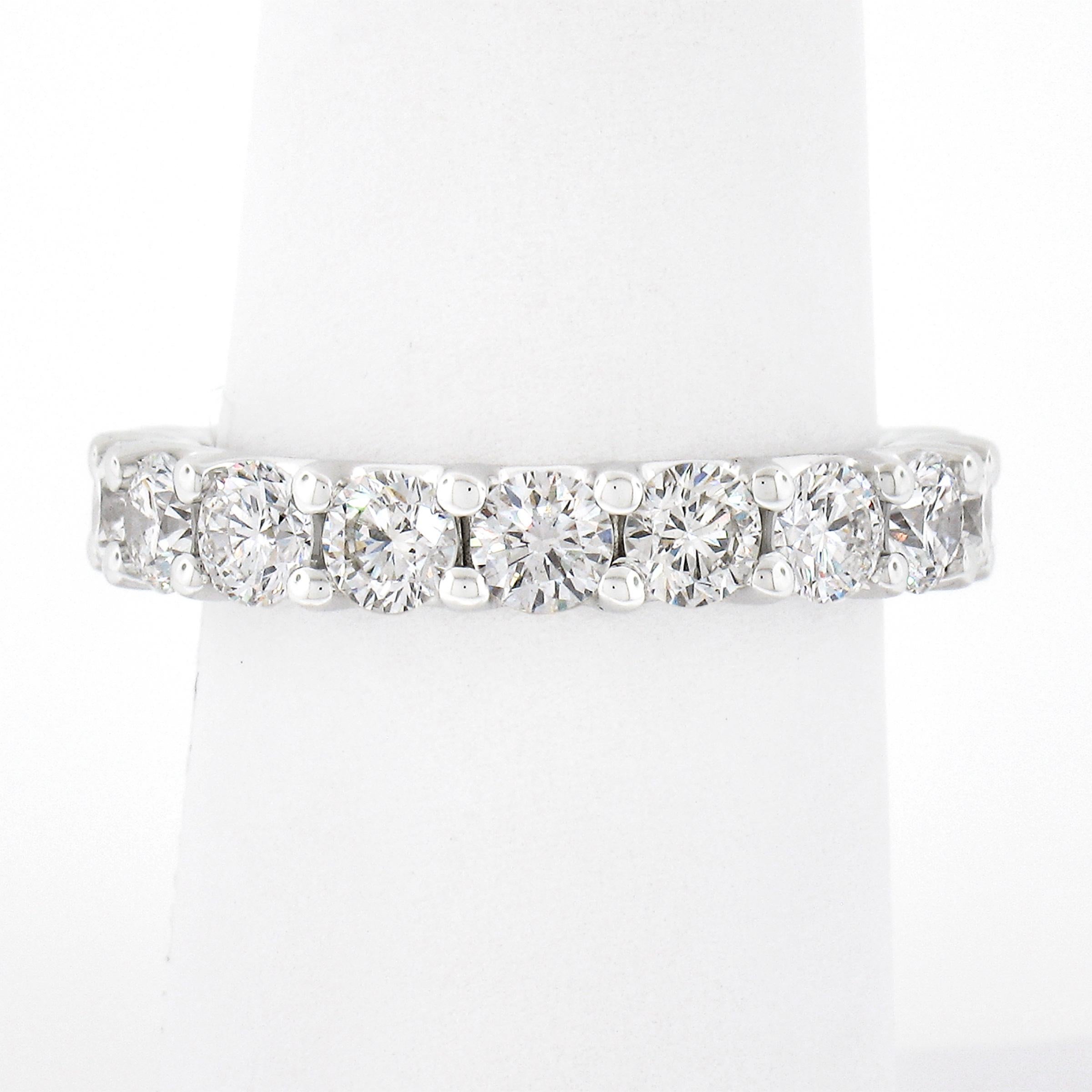 This stunning eternity band ring is crafted in solid 14k white gold and features 18 gorgeous diamond stones which are neatly shared-prong set throughout the entire band. Each of these super fiery round brilliant cut diamonds display a very nice