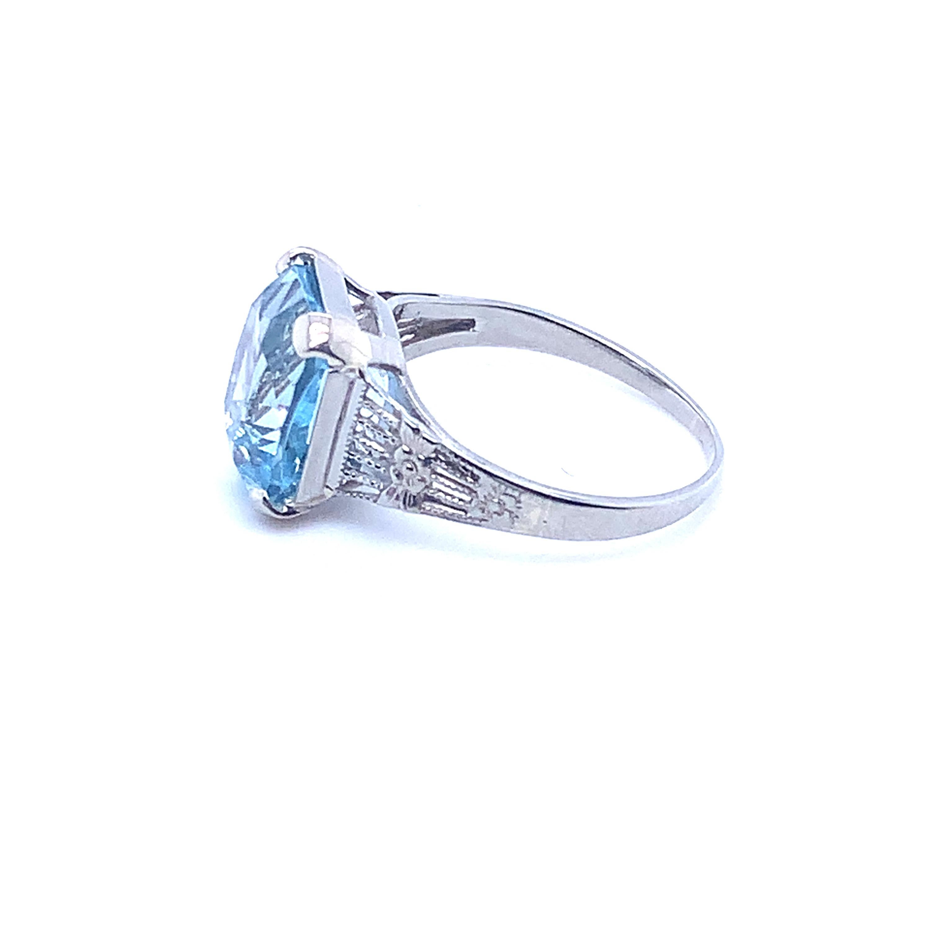 Art Deco 14K white gold filigree ring featuring 3.34ct antique cushion cut aquamarine, measuring about 10mm x 9mm. The color of the gem is best represented on the hand, not as blue as shown in the light box. The ring fits a size 4 3/4 finger, weighs