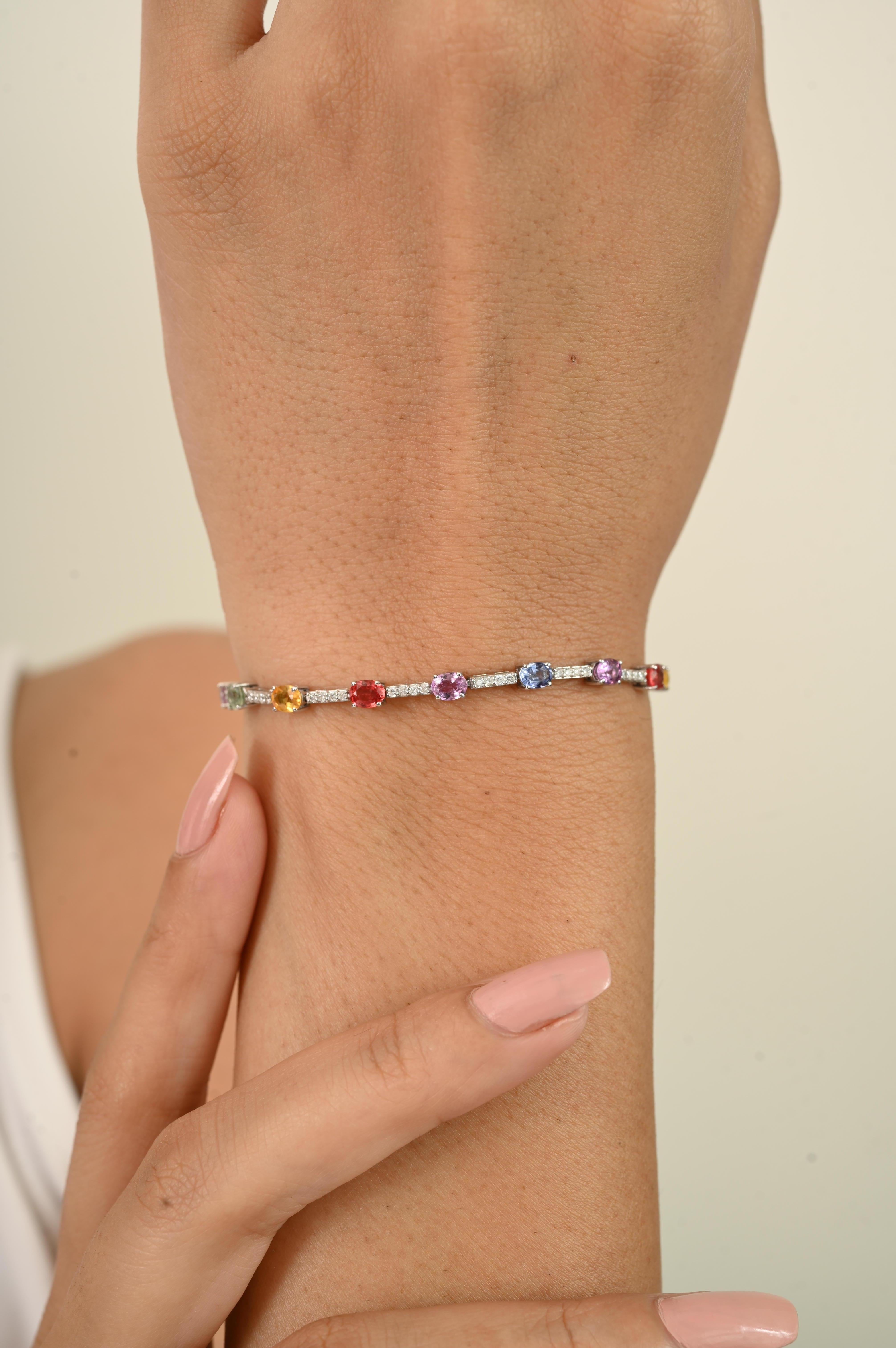 This Genuine Oval Multi Sapphire Tennis Bracelet in 14k Solid White Gold endlessly sparkling natural multi sapphires weighing 3.55 carats and Diamonds weighing 0.48 carats. 
Sapphire stimulate concentration and reduces stress.
Designed with oval-cut