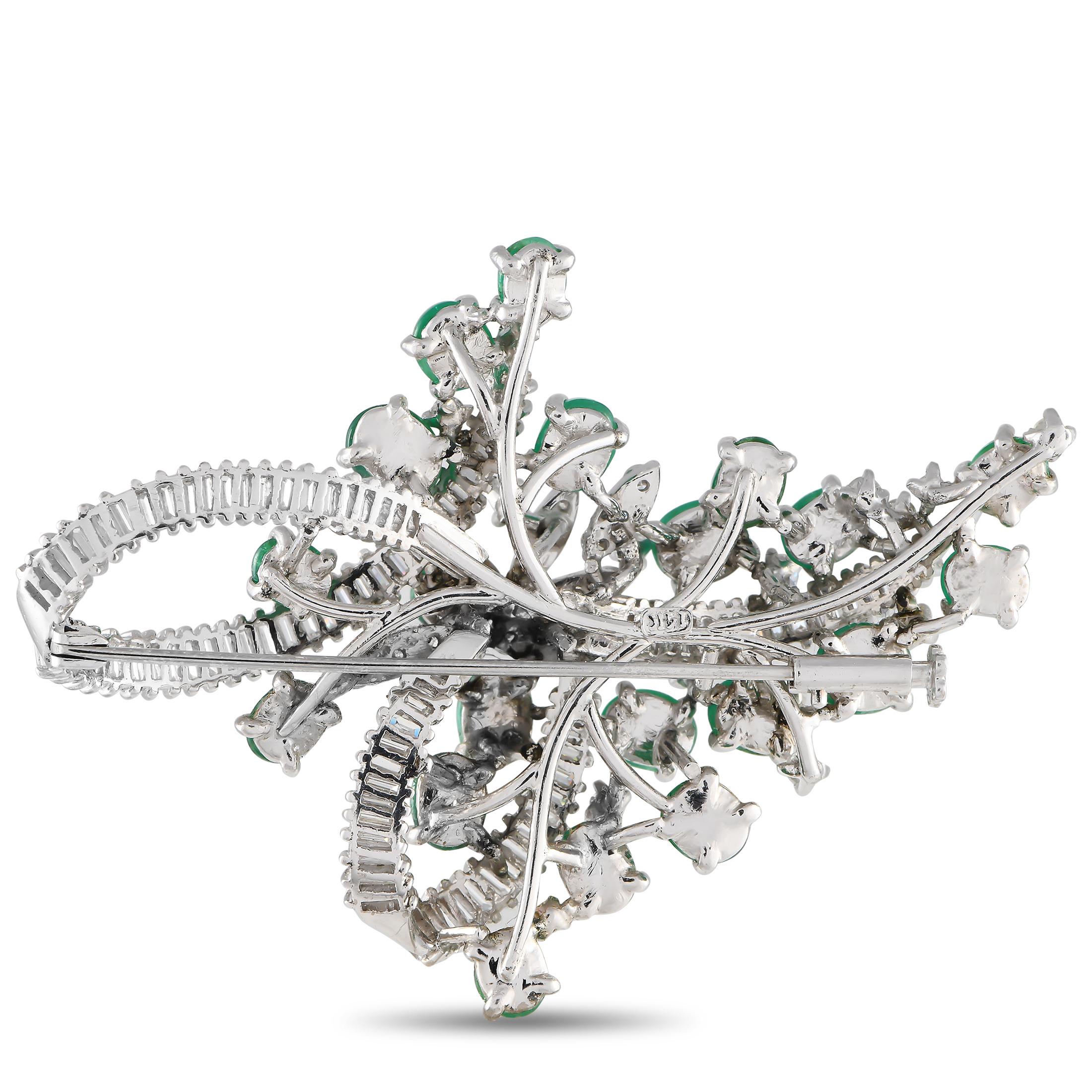 Diamond baguettes and round-cut diamonds with a total weight of 3.60 carats make this luxurious 14K white gold brooch a scintillating addition to any ensemble. Further elevated by radiant emeralds totaling 8.50 carats, this timeless accessory