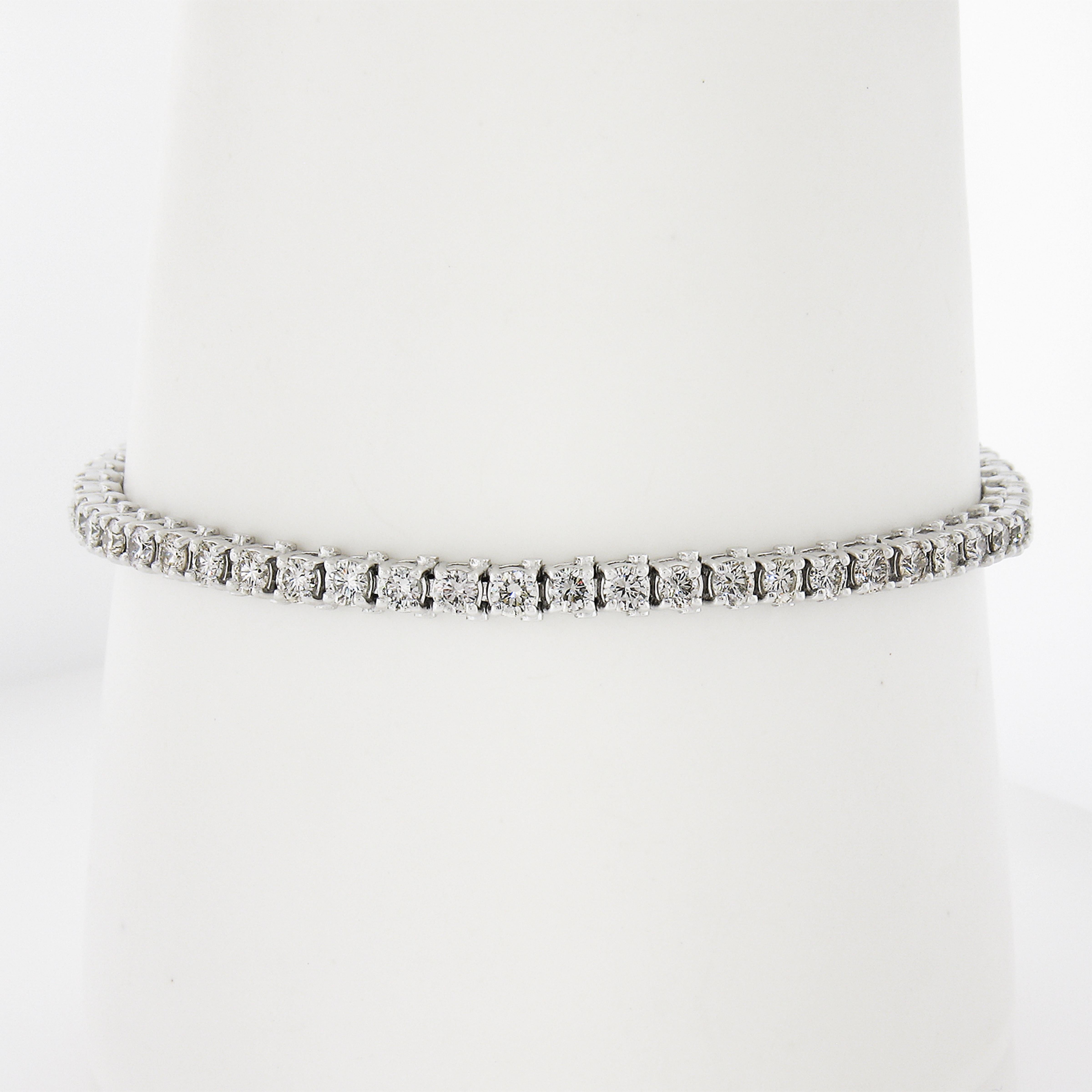 --Stone(s):--
(57) Natural Genuine Diamonds - Round Brilliant Cut - Prong Set - H-K Color - VS2-SI2 Clarity
Total Carat Weight: 3.90 (approx.)

Material: Solid 14K White Gold
Weight: 12.5 Grams
Type: Tennis Line Link
Chain Length: Measures 7 Inches