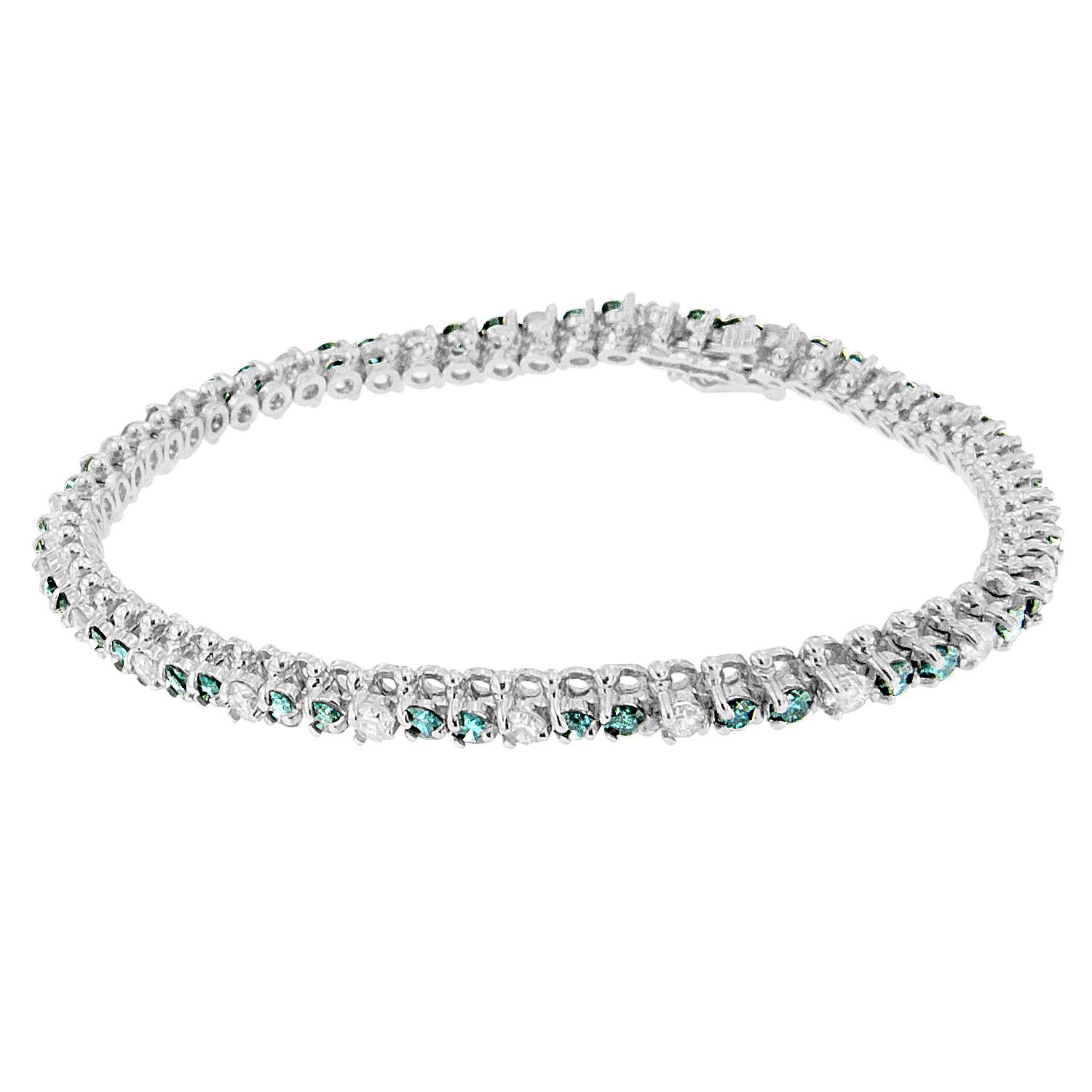 This beautiful 14 karat white gold bracelet has 4 5/8 carat round and treated blue colored shaped diamonds set up in the channel form giving it a classy look. This definitely makes for an exciting gift for that special one! Bracelet has 66 natural,