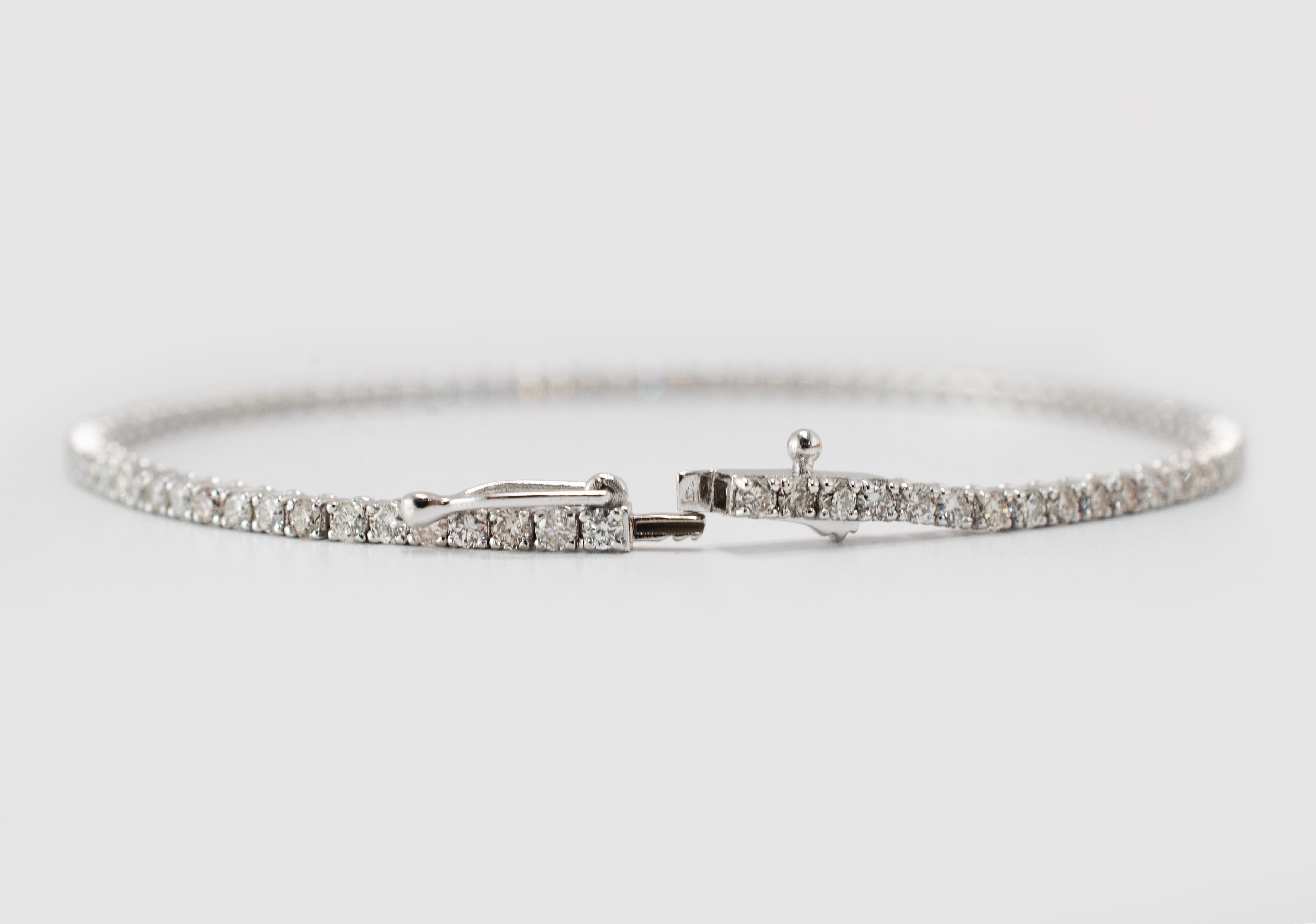 Gender: Women's

Metal Type: 14K White Gold

Length: 7.00 inches

Weight: 6.60 grams

Custom made polished rhodium plated 14K white gold, diamond tennis bracelet.  Engraved with 
