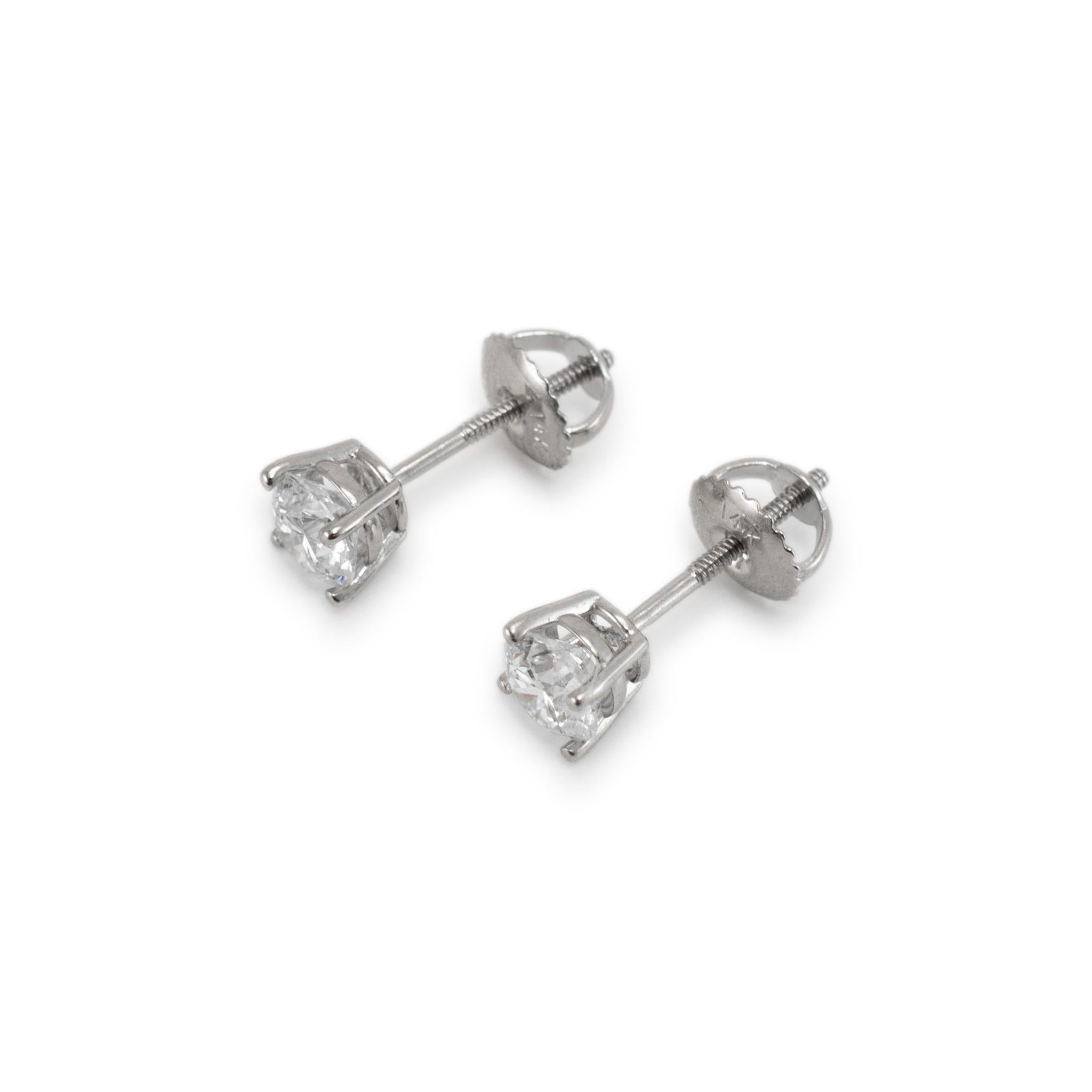 Metal Type: 14K White Gold

Diameter: 5.05 mm

Weight: 1.07 grams

One pair of 14K white gold diamond stud earrings with screw backs. The metal was tested and determined to be 14K white gold. Engraved with 