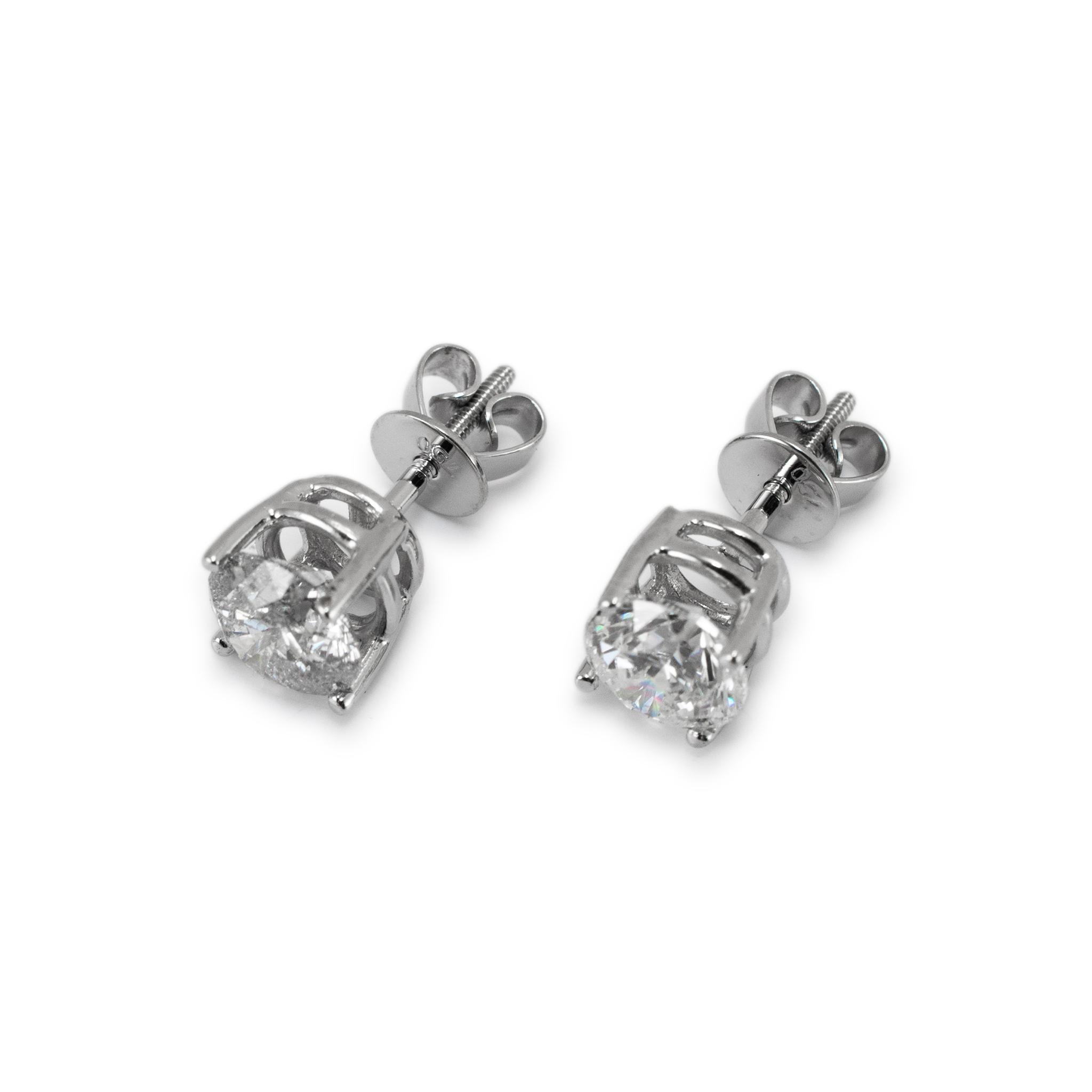 Metal Type: 14K White Gold

Diameter: 6.50 mm

Weight: 1.60 grams

One pair of 18K white gold diamond stud earrings with screw backs. The metal was tested and determined to be 18K white gold. Engraved with 