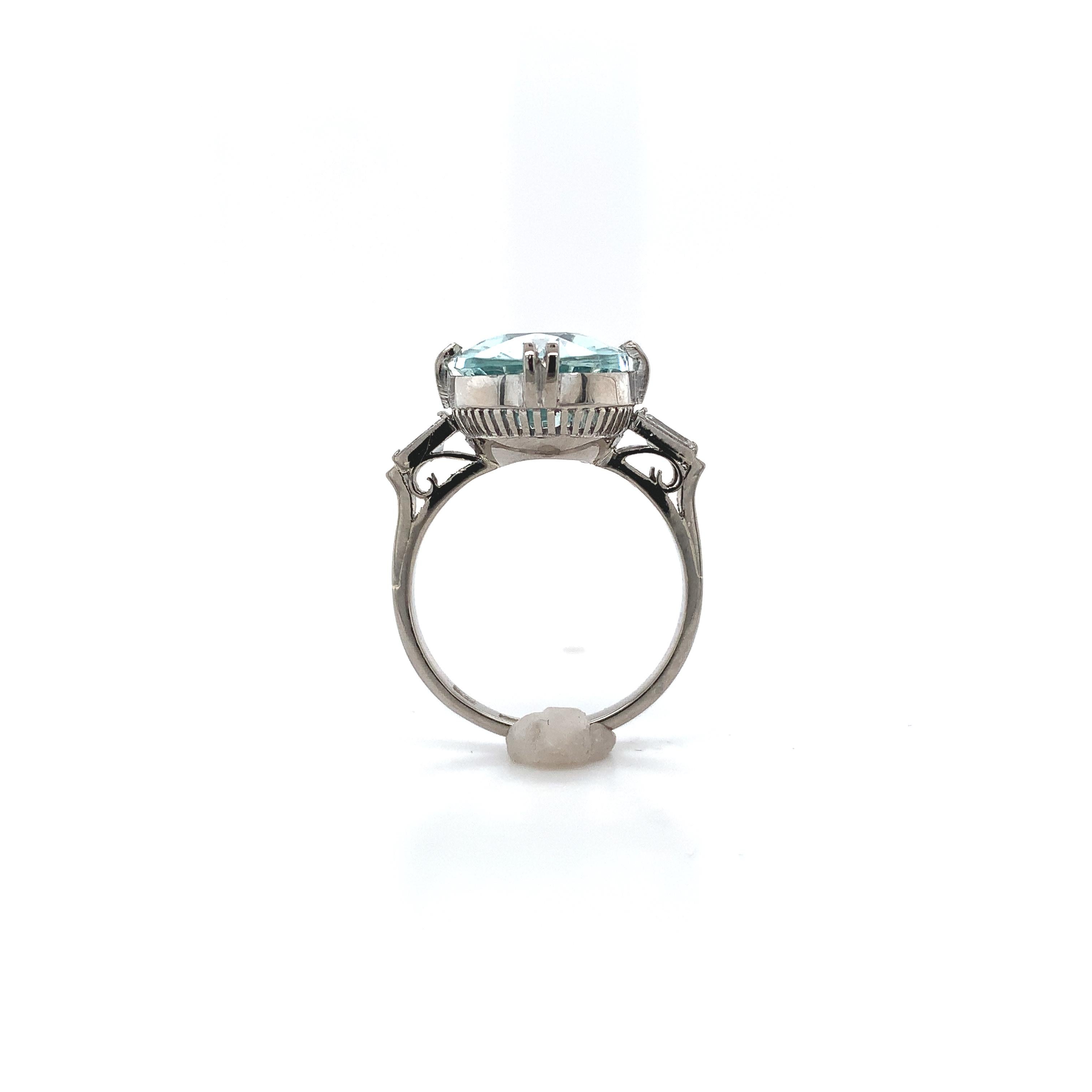 14K white gold 4.14 carat aquamarine ring. The light blue aquamarine is a beautiful specialty antique oval cut measuring about 13mm x 11mm. There are 2 diamond baguette accents measuring about 4mm x 2.3mm. The ring fits a size 5 finger and weighs