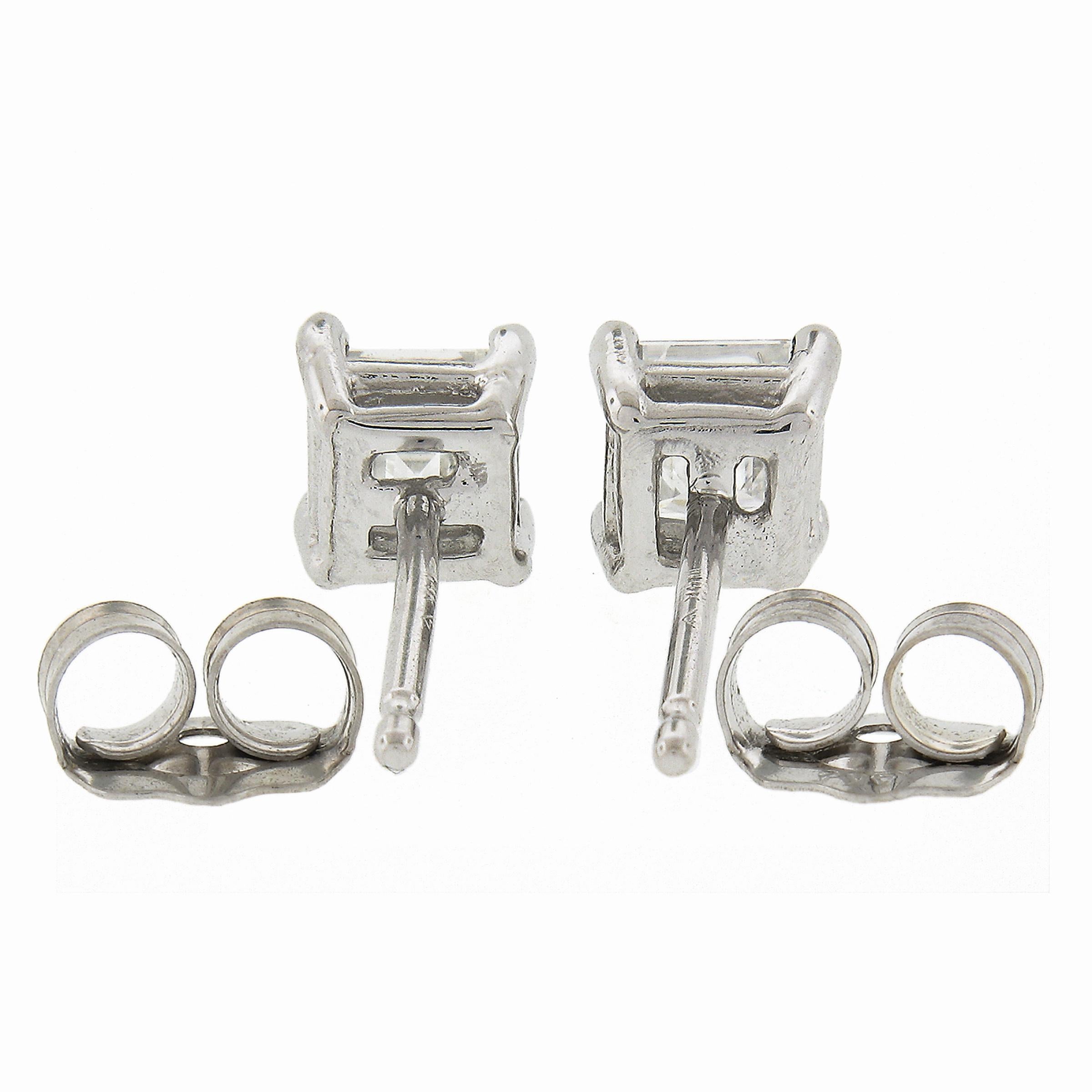 Here we have a classic pair of diamond stud earrings. They feature a pair of diamonds with a square step cut that together total approximately 0.45 carats in weight. These high quality diamonds are neatly 4-prong set in their square shaped open work