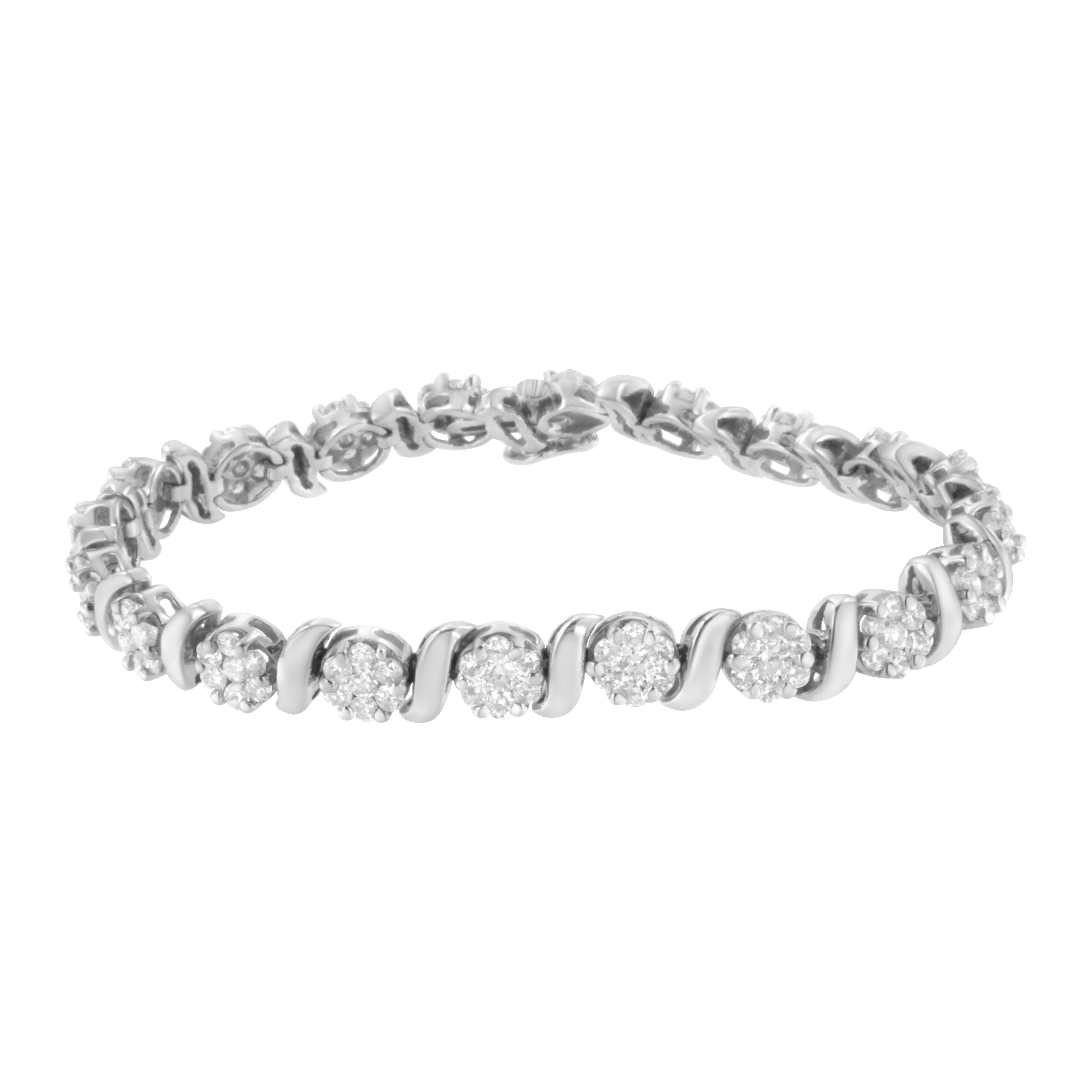 Add a little sparkle to your outfit with this 14k white gold link bracelet. Soft white gold ribbons curve and create S shaped links that sit in between circular round cut diamond clusters. 5 1/4ct TDW of glimmering diamonds are displayed on this