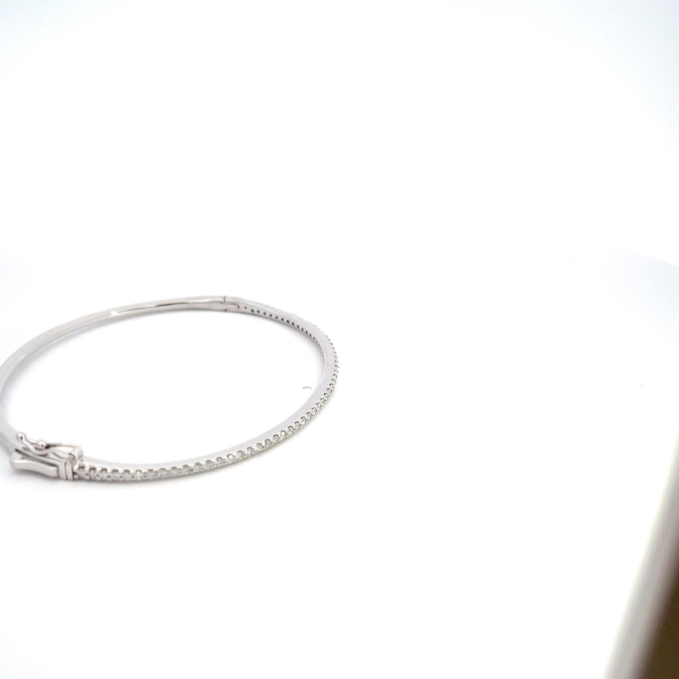 Introducing our exquisite 14K White Gold 0.63ctw Diamond Bangle – a timeless masterpiece that effortlessly combines sophistication and luxury. Crafted with meticulous attention to detail, this bangle is a true symbol of elegance.

Made from lustrous