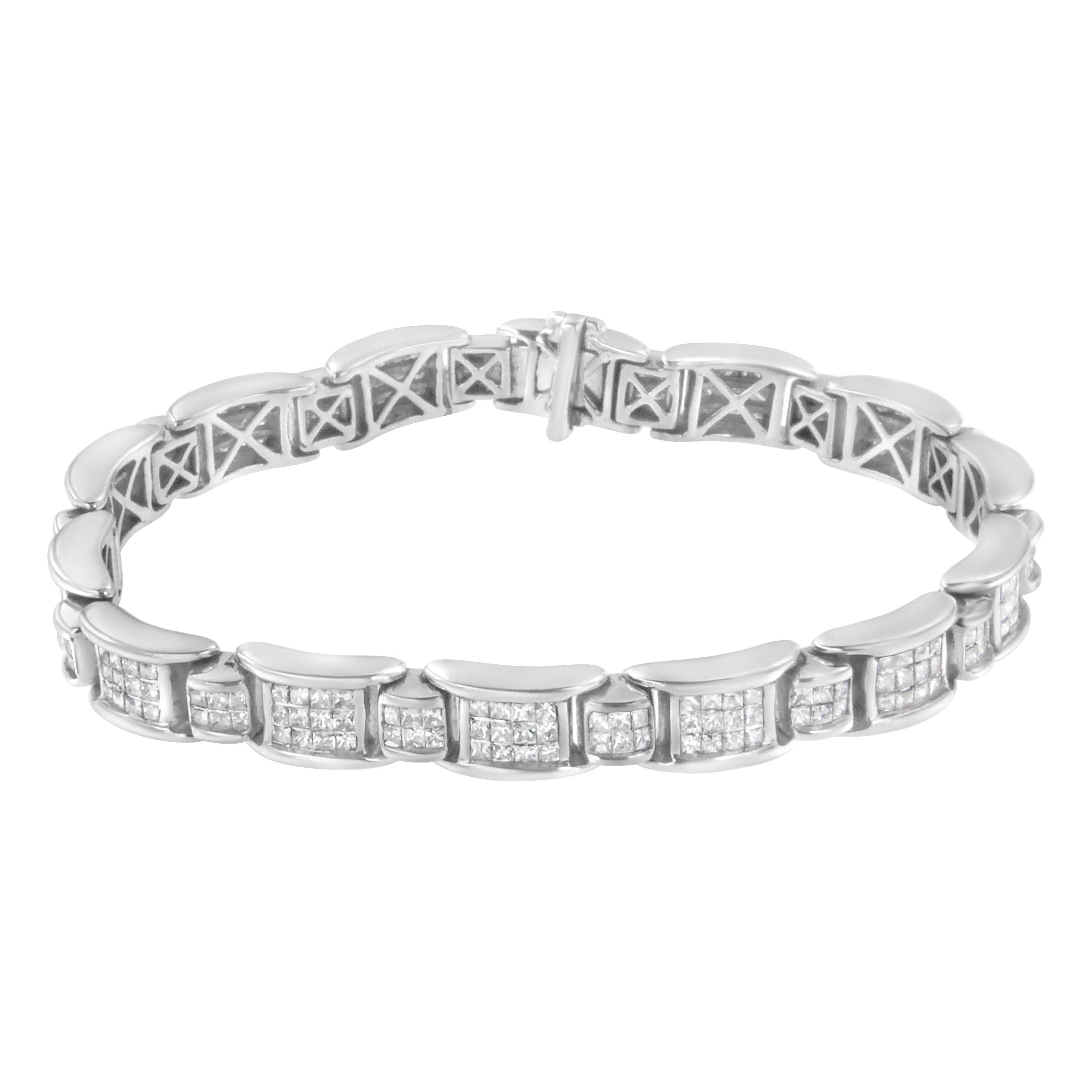 This geometric pattern link bracelet is a timeless piece. Small white gold bands inlaid with six princess cut diamonds link with larger bands inlaid with an additional twelve princess cut diamonds. 5 carat TDW in diamonds shine in this design. A box