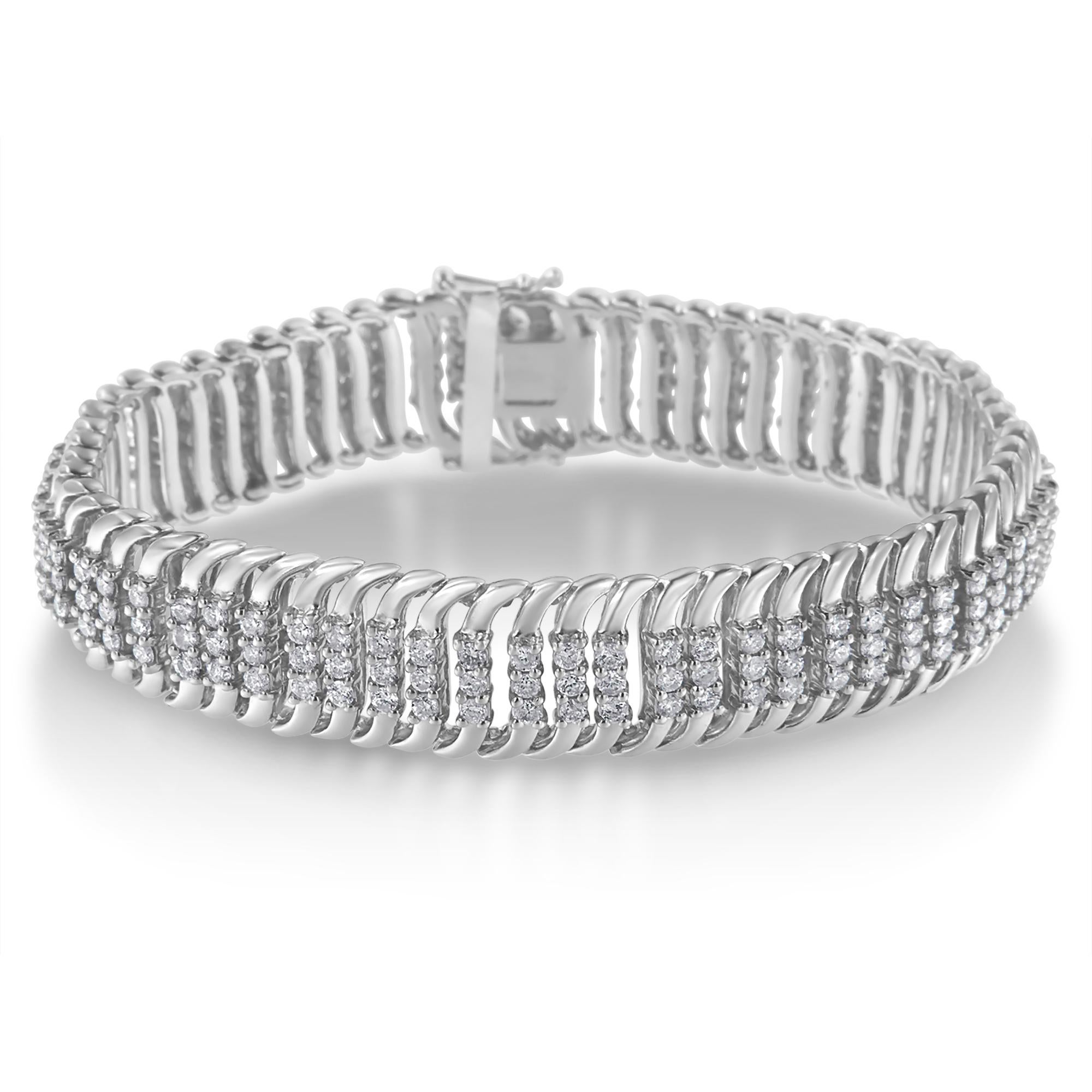 This enchanting diamond bracelet is crafted in 14k white gold and showcases 5 carats TDW of dazzling round cut diamonds. Soft 