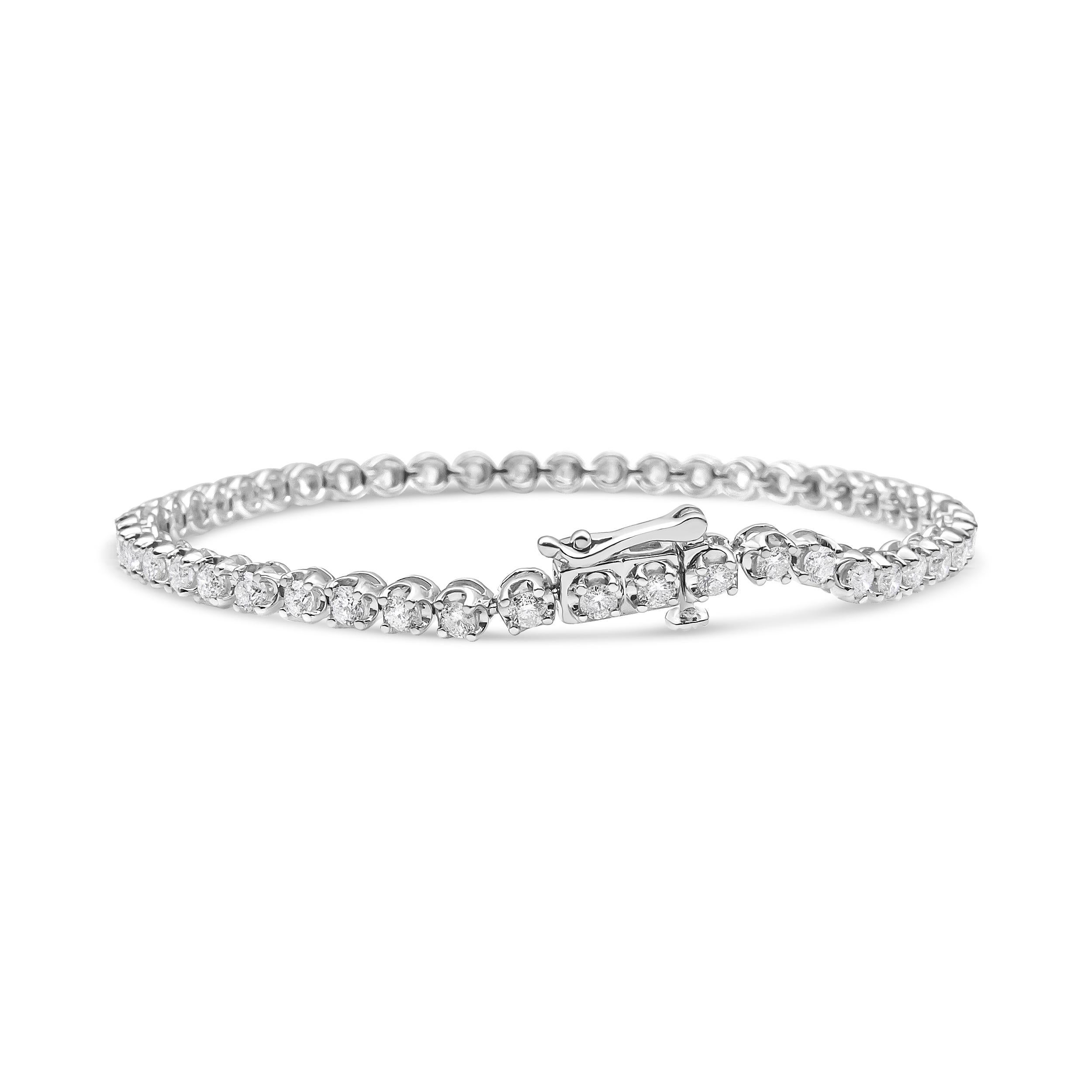 Magnificently striking, this glamorous tennis bracelet is embellished with an impressive total diamond weight of 5.0 c.t. This piece is crafted in 14k white gold, a metal that will stay tarnish free for years to come! 52 round-cut diamonds are set