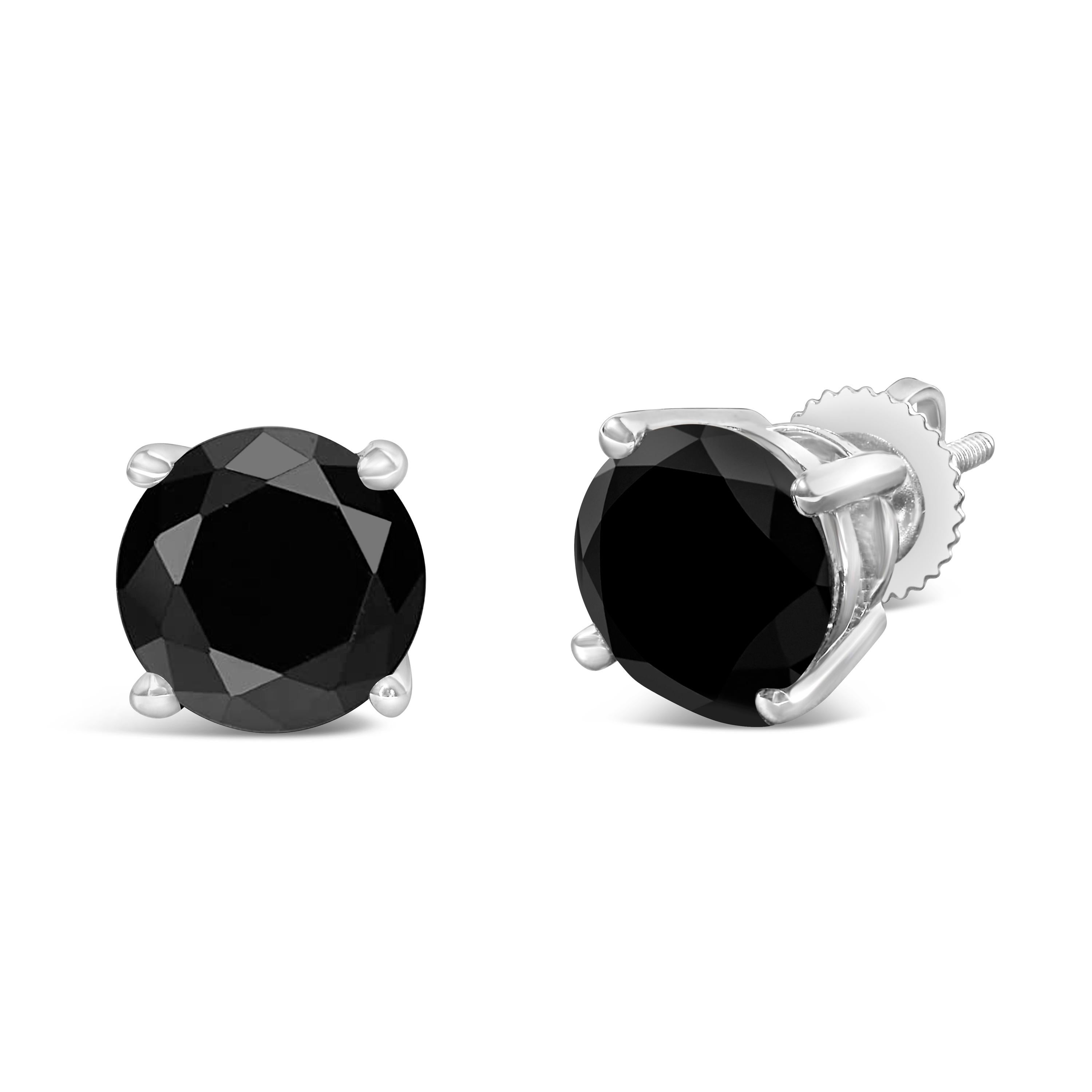 Elegant and timeless, these gorgeous 14K white gold solitaire stud earrings feature bold and beautiful heat treated, color enhanced black diamonds. The earrings feature screw back closures. The notched posts and friction backs keep these pierced