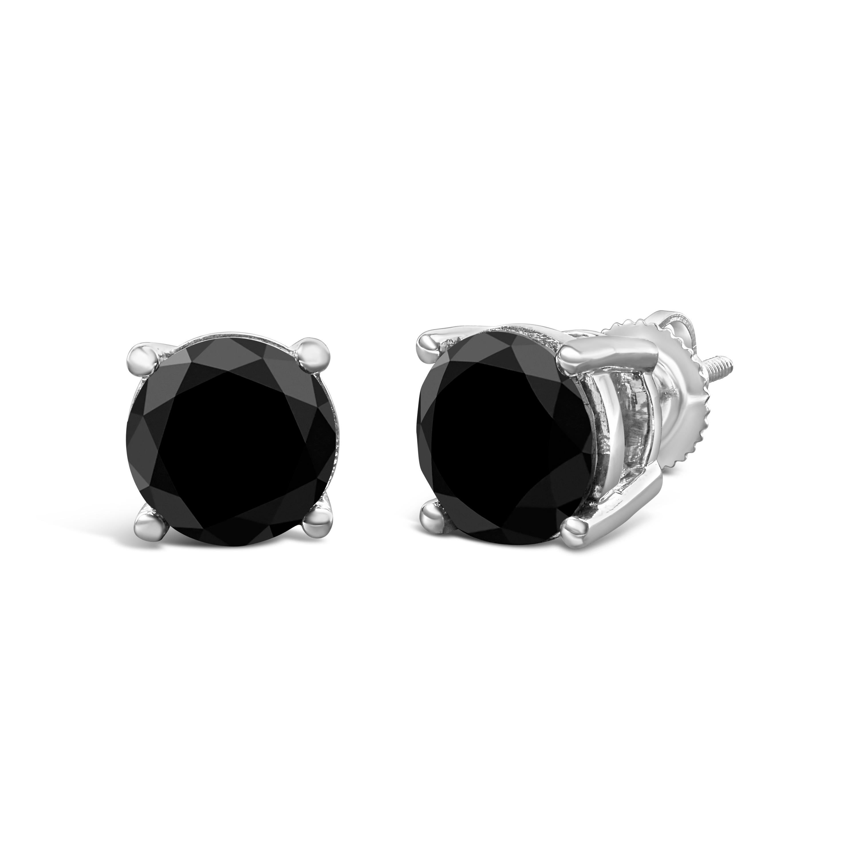Elegant and timeless, these gorgeous 14K white gold solitaire stud earrings feature bold and beautiful heat treated, color enhanced black diamonds. The earrings feature screwback closures. The notched posts and friction backs keep these pierced