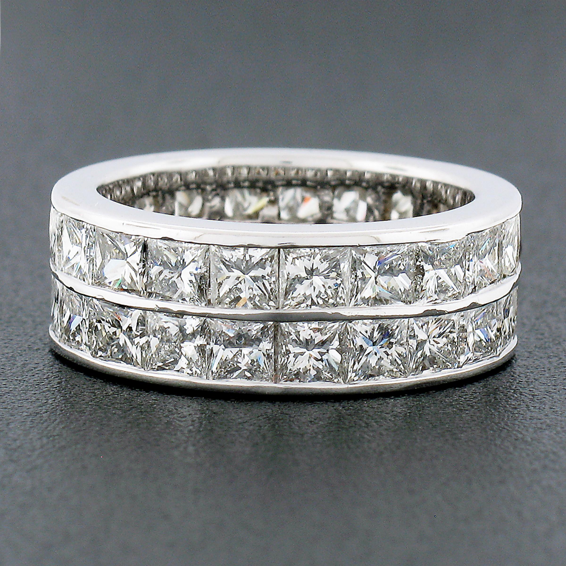 Here we have an absolutely gorgeous diamond eternity band ring crafted from solid 14k white gold. The wide band features 44, very fine quality, princess square cut diamonds, totaling approximately 6 carats in weight, that are perfectly channel set