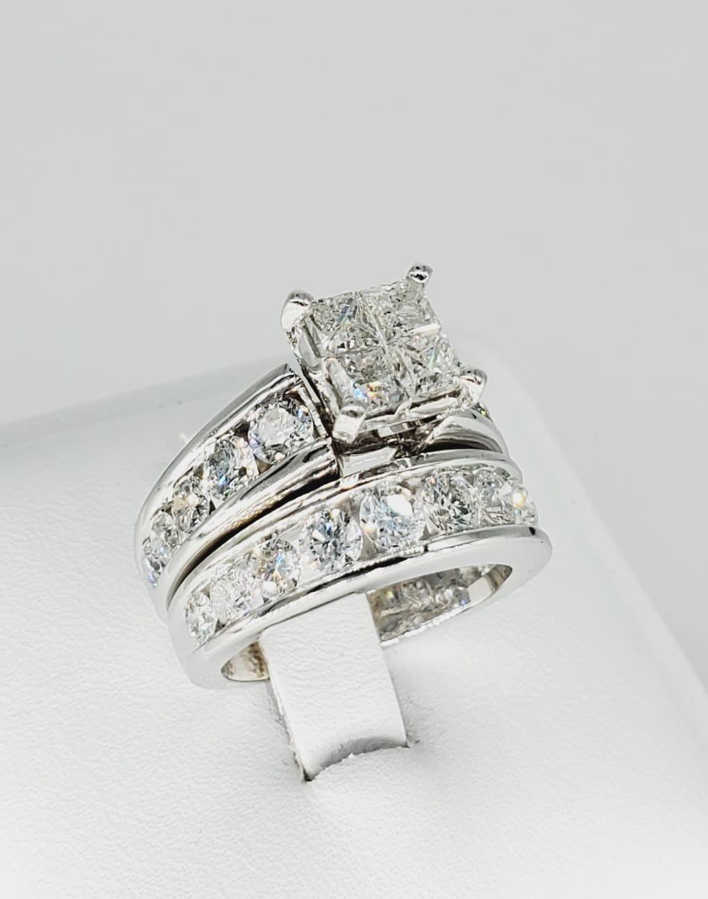 14k White Gold 6.25 Carat Diamonds Engagement Ring Set. Astonishing design with channel settings across the band and main ring matching a perfect set. The ring is a size 6.5 and weights approx 14.50 grams. The Diamonds are natural and are very clean