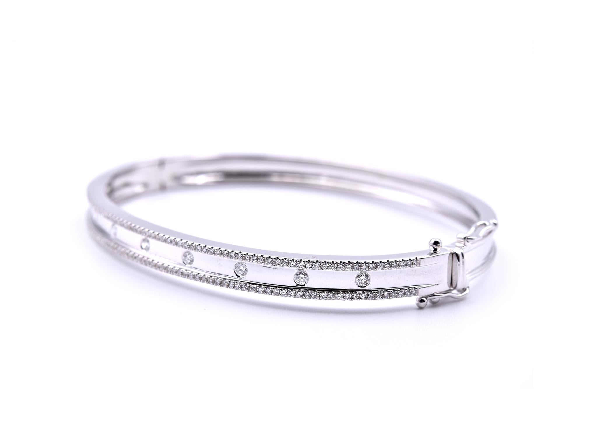 Designer: custom
Material: 14k white gold
Diamonds: round brilliant cut = .62cttw
Color: G
Clarity: VS
Dimensions: bangle will fit a 6 ½ -inch wrist
Weight: 16.56 grams
