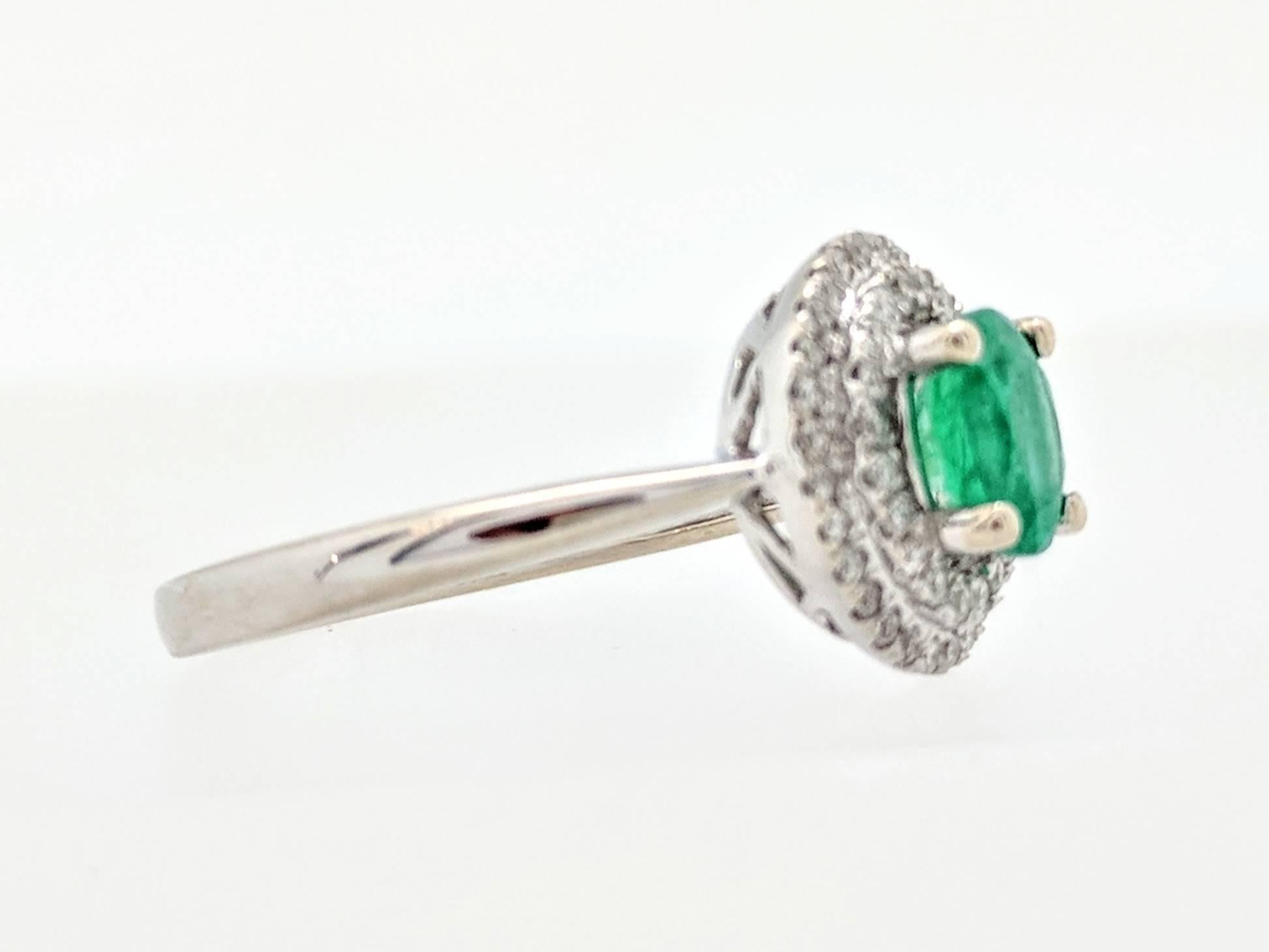 Oval Cut 14 Karat White Gold .66 Carat Emerald and Diamond Double Halo Ring