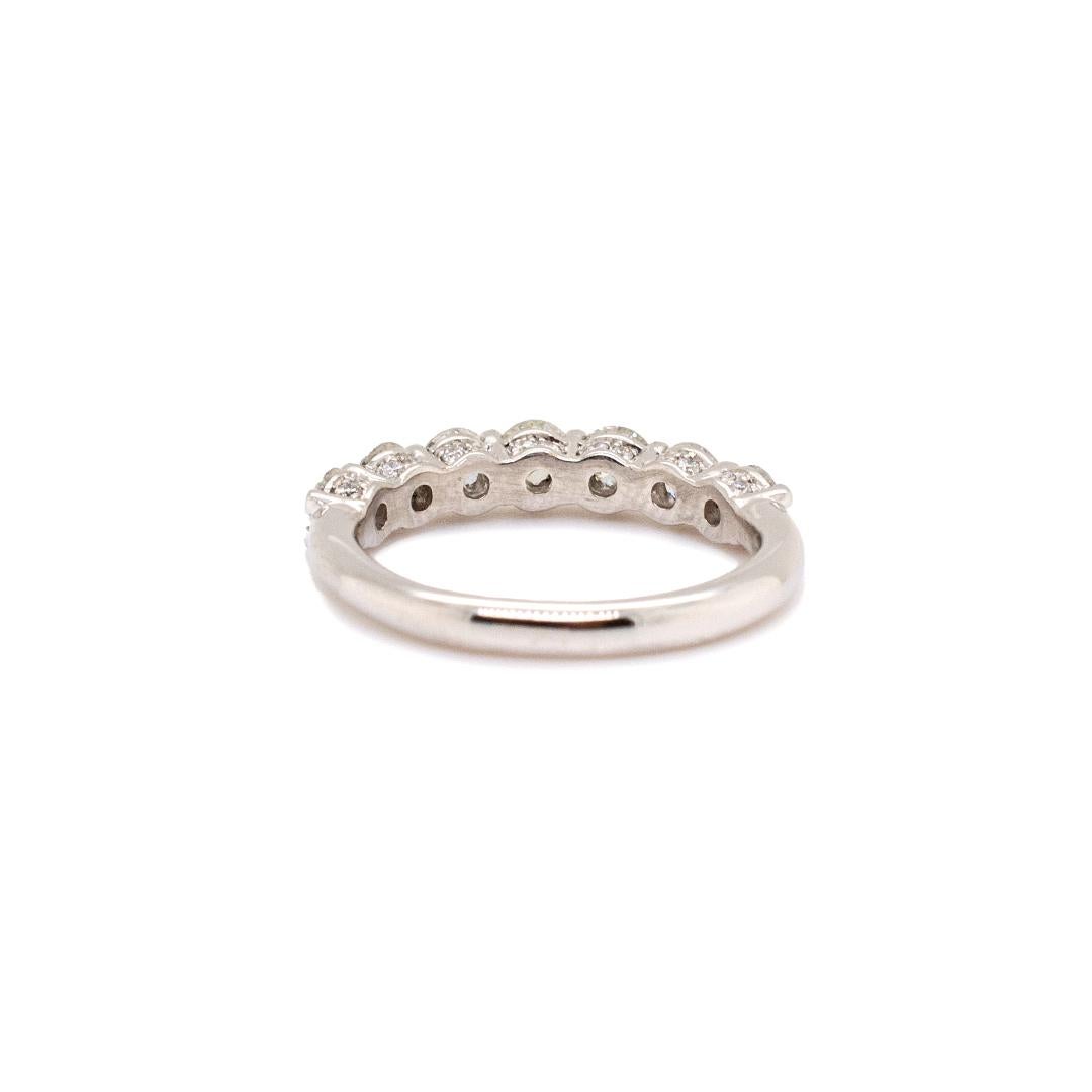 One ladies custom made polished 14K white gold seven-across, diamond eternity ring with a slightly rounded shank. The ring is a size 4.25, is 1.43mm thick and measures approximately 2.12mm tapering to 1.90mm in width and weighs a total of 2.30