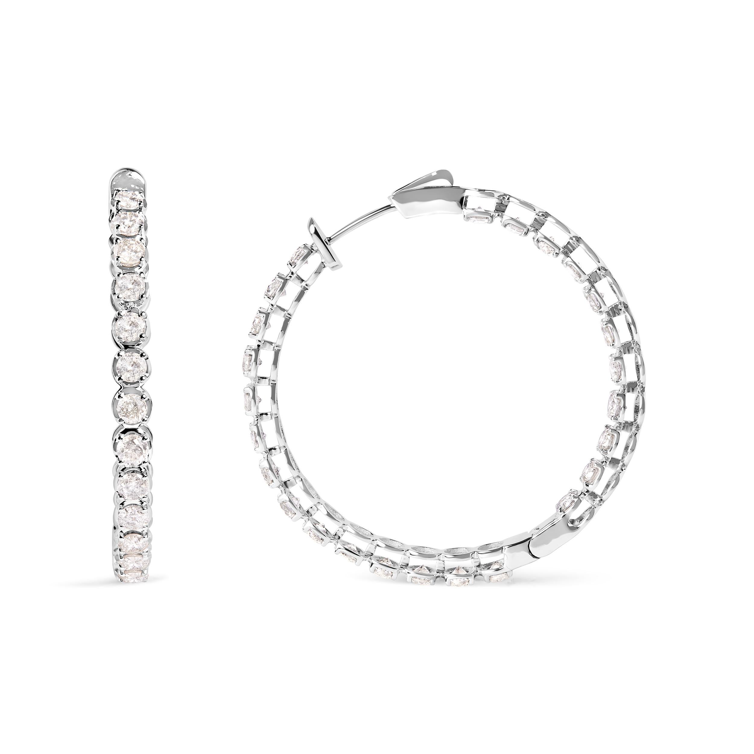 Expertly crafted from 14K white gold, these elegant hoop earrings are an embodiment of timeless sophistication. Encrusted with an impressive 7.0 carats total weight of diamonds, they radiate an enticing sparkle with an I-J color and I2-I3 clarity,