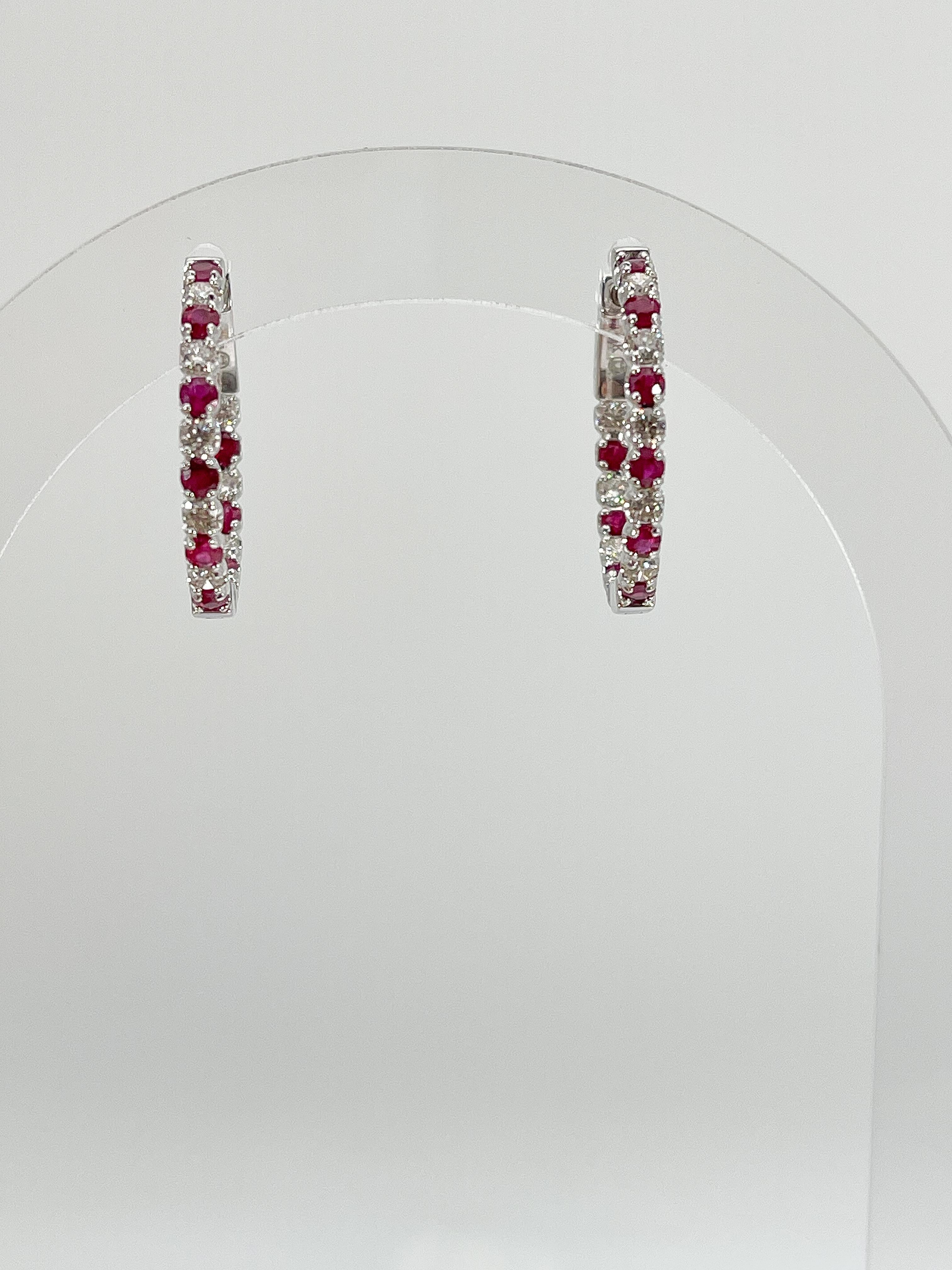 14k white gold .78 CTW diamond and 1.15 CTW ruby hoop earrings. The stones in these earrings are round, the measurements are 23.1 x 23.1, and they have a total weight of 5.12 grams.