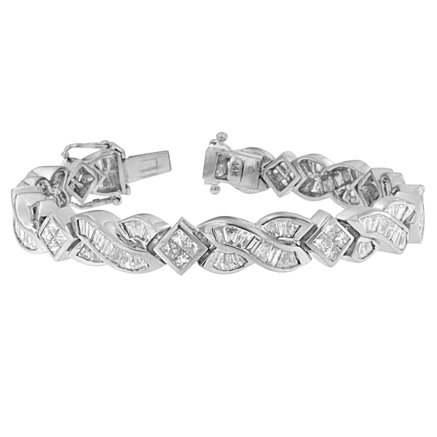Shaped to perfection, with plenty of sparkle! This 14 karat white gold bracelet flaunts over 8 carats of diamonds, scattered across a mix of textured cubes and wavy links, for a style like no other. Bracelet has 151 natural, baguette diamonds. Each