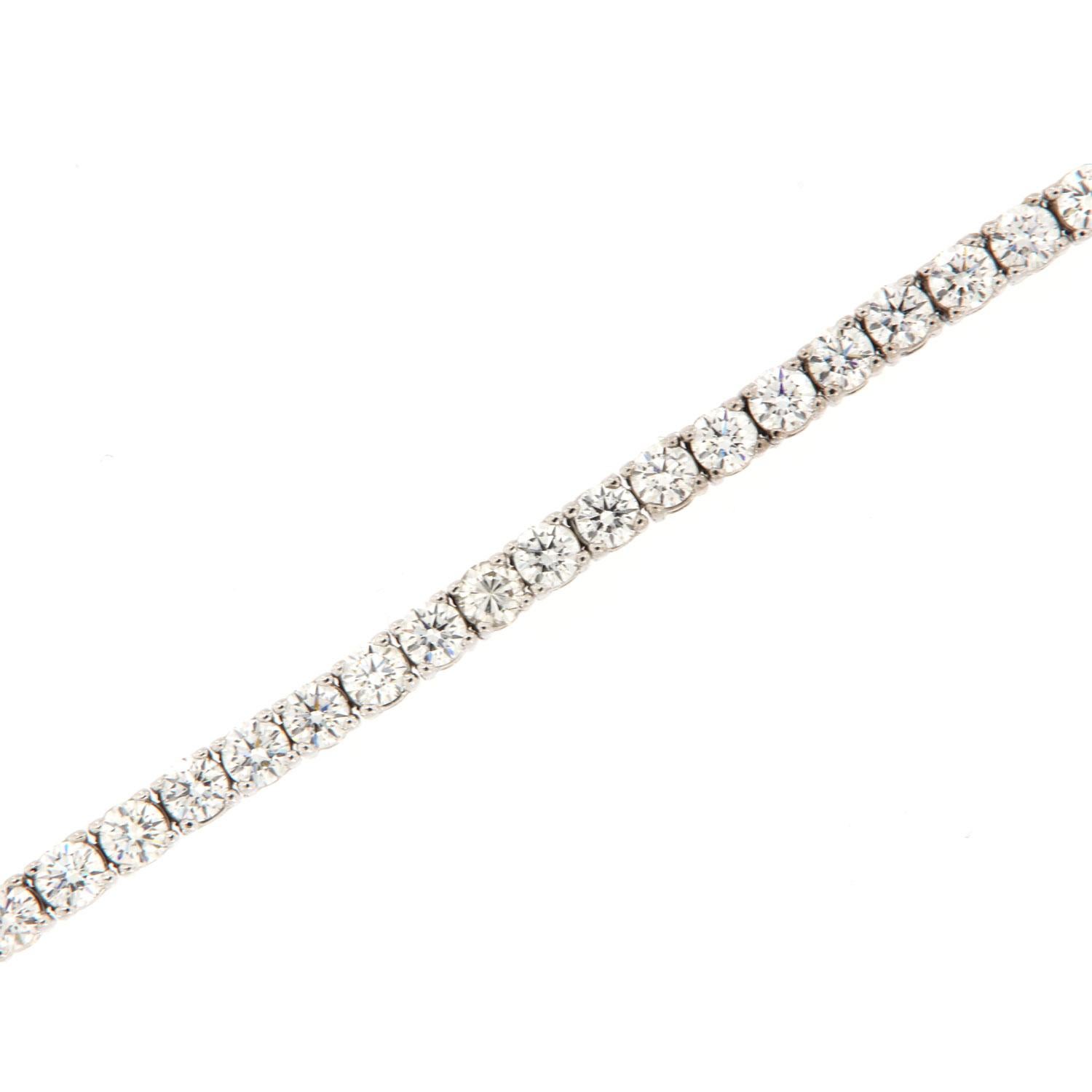 This tennis bracelet features perfectly matched Forty-Four (44) Round shape ideal cut diamonds in a total weight of 8.66 carats set in four (4) prongs 14k white gold. Average color G Average clarity VS2 in an excellent luster
The bracelet is 7