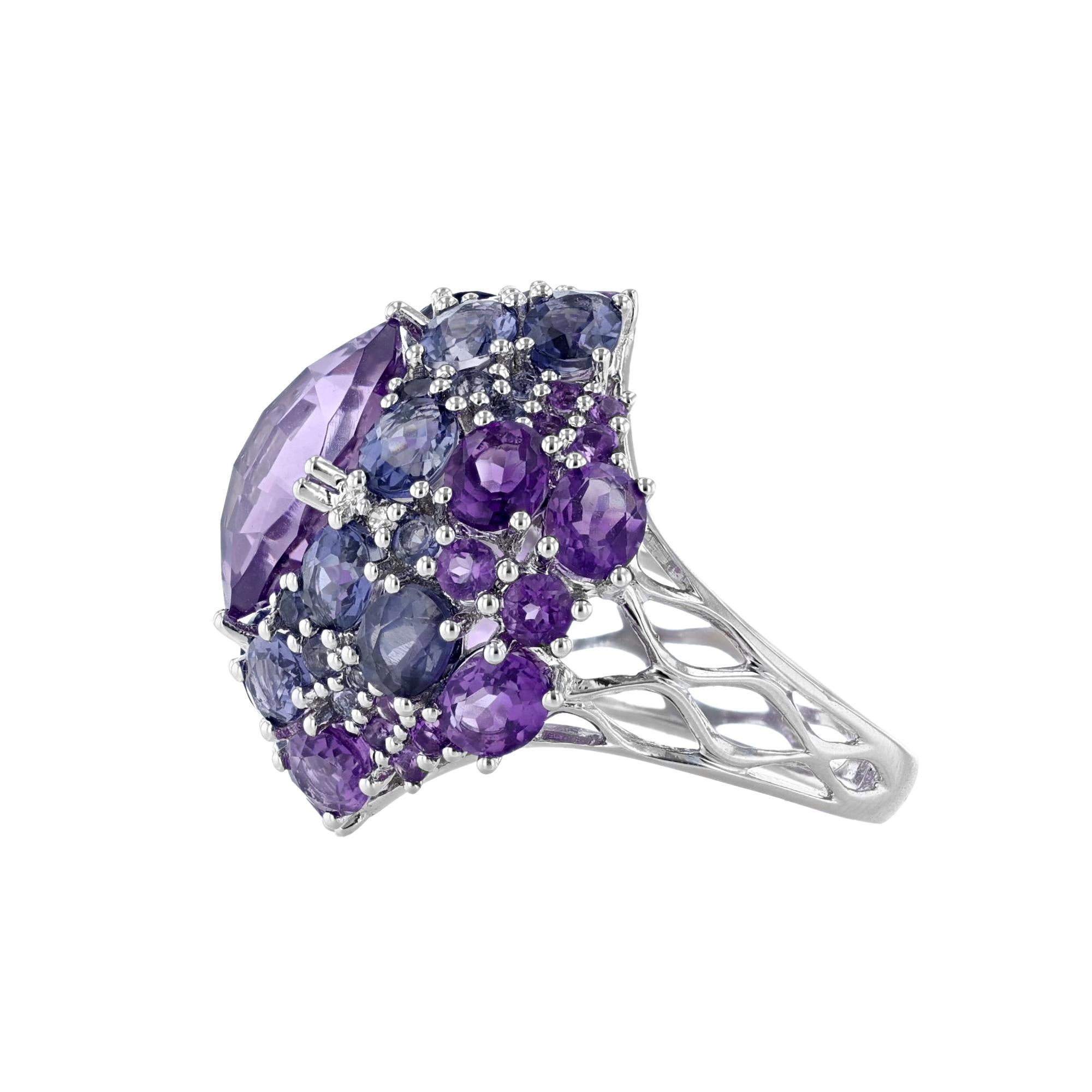 This ring is made in 14K white gold and features amethyst weighing 9.12 carats. Along with Iolite weighing 4.29 carats, and diamonds weighing 0.06 carat.